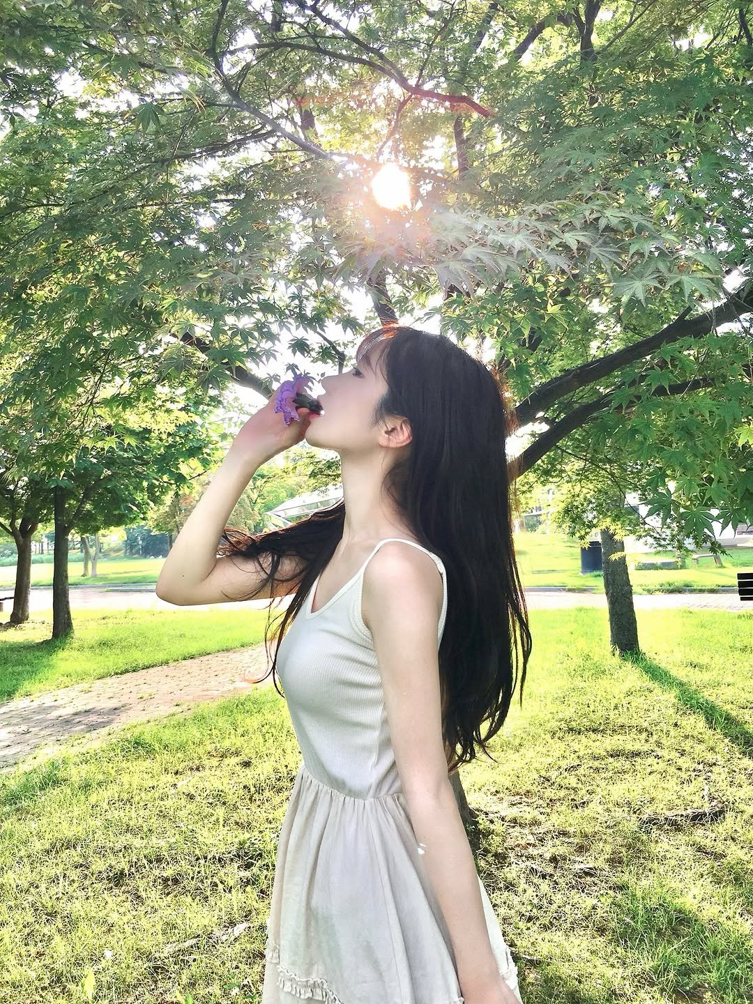 Photo by 이로아 on July 11, 2025. May be an image of 1 person, sundress, park and text.