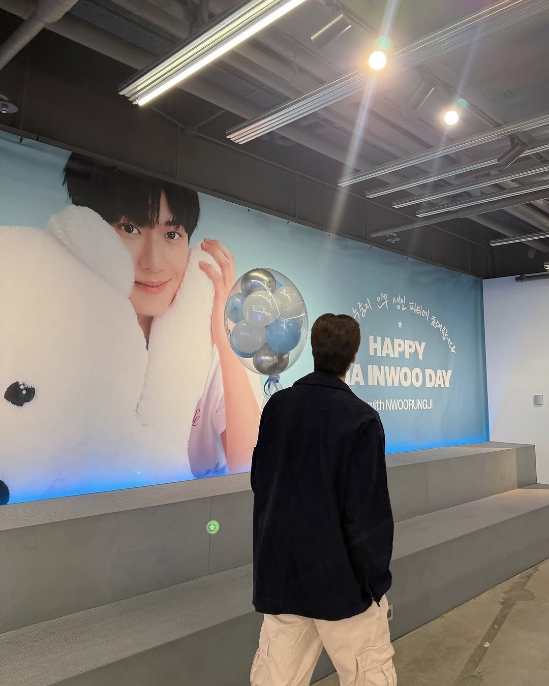 Photo by 나인우 NA INWOO on September 18, 2025. May be an image of one or more people, bangs, duffle coat and cornflower.