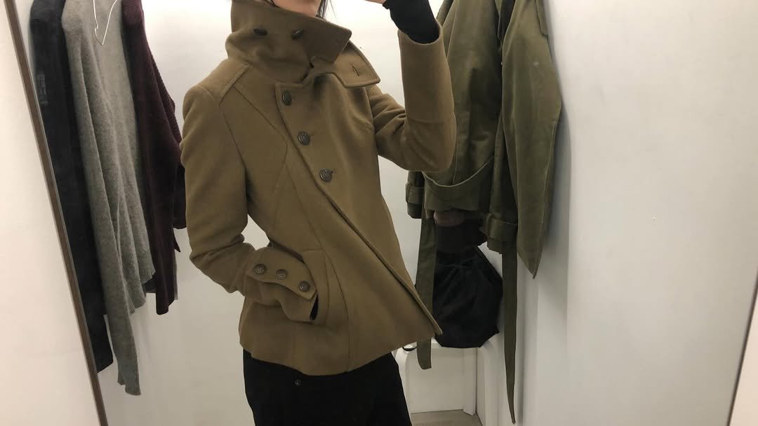 Photo shared by kimyoung on December 20, 2025 tagging @ayadz.vintage.studio. May be an image of duffle coat, overcoat, clothes hanger, jacket, raincoat, parka, fleece and text.