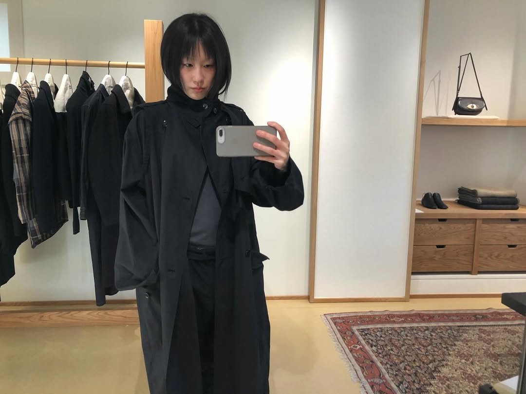 Photo shared by kimyoung on December 19, 2025 tagging @lemaire. May be an image of duffle coat, overcoat, clothes hanger, parka and text.