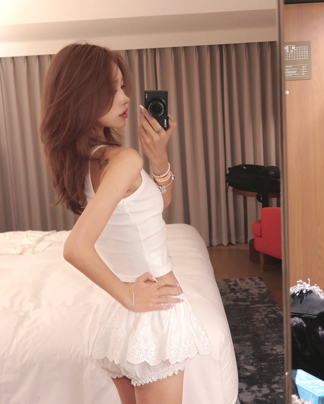Photo by ָ 「 준희 」 on July 31, 2025. May be an image of 1 person, hair, sleepwear, slip, miniskirt, dress, chemise and text.