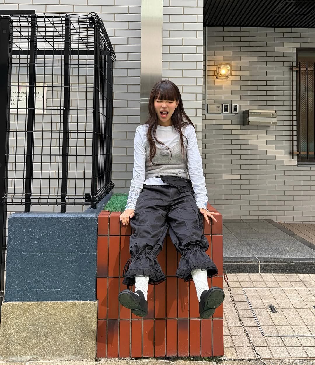 Photo shared by 지연 on November 19, 2025 tagging @_tuomio. May be an image of child, duffle coat, parka, sweatpants, brick wall and text.