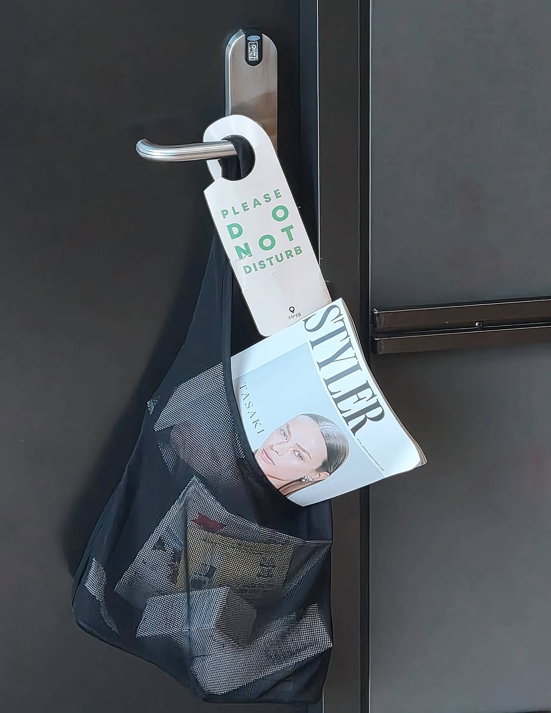 Photo shared by 고서연 on September 26, 2025 tagging @styler_mag. May be an image of 1 person, towel rack, light switch, grocery bag, padlock, clothes hanger, clipboard, rack and text that says 'L PLEASE PLEASE O D N NOT O T DISTURB 4 6や STYLER ςΚ YLER ER o 대 EREREE'.