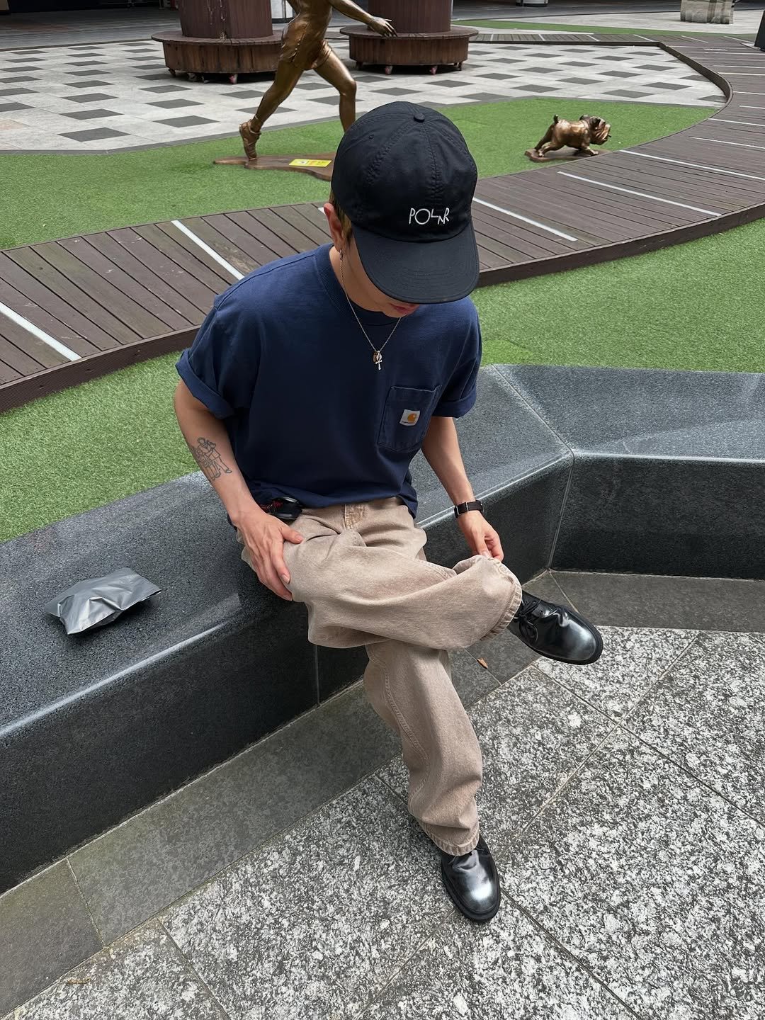 Photo shared by 피로 on June 08, 2025 tagging @drmartensofficial, @fuckingawesome, and @carharttwip_kr. May be an image of golf, wingtip shoes, statue, park and text.