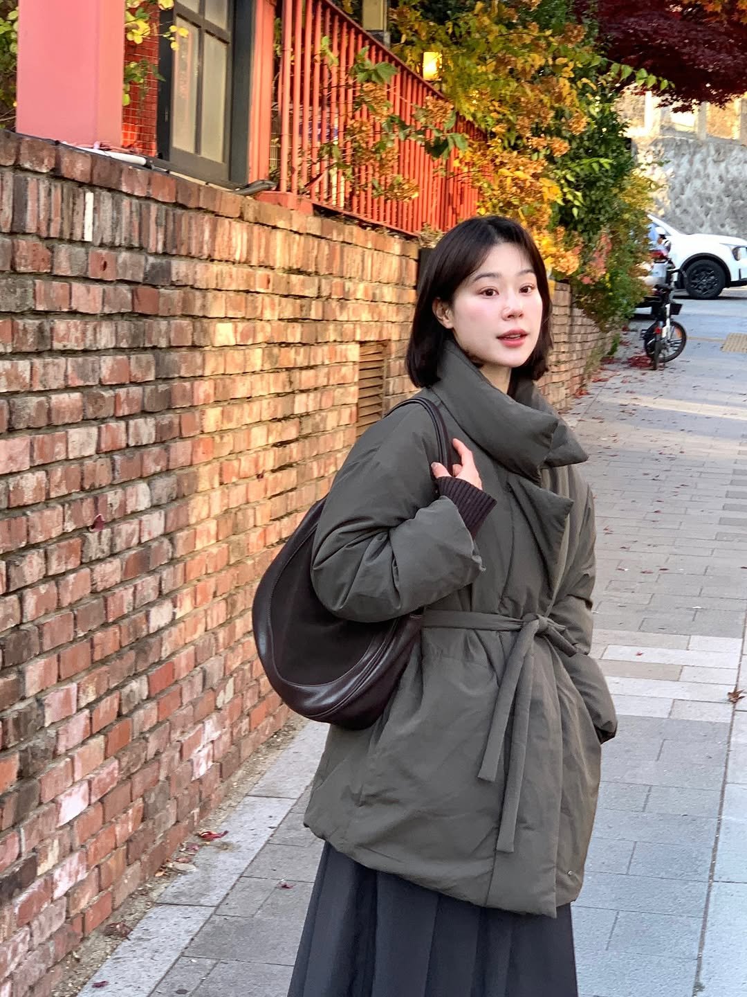 Photo shared by 주미 on November 25, 2025 tagging @maisonloeuvre. May be an image of duffle coat, overcoat, turtleneck, parka and text.