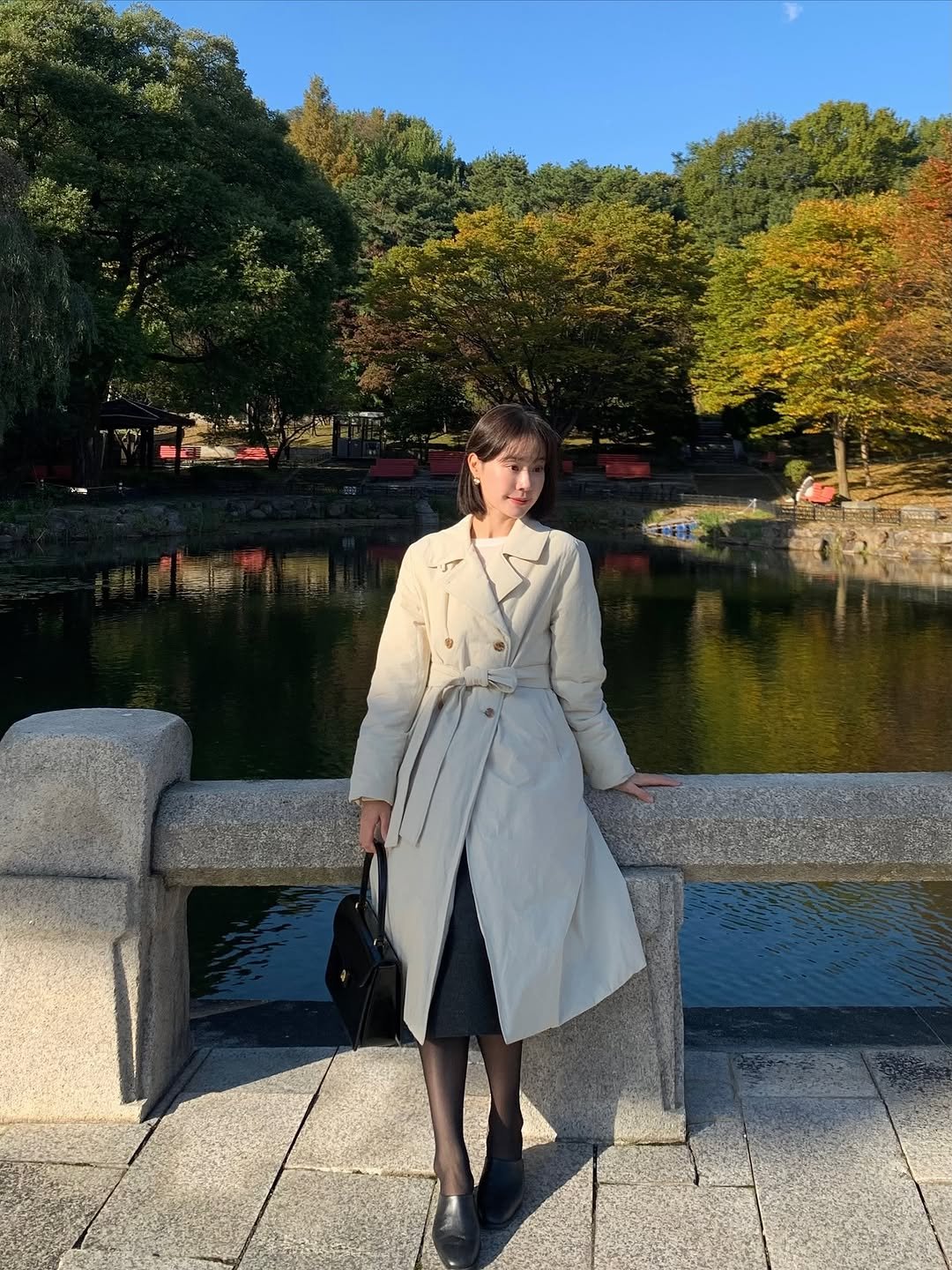 Photo shared by 주미 on October 29, 2025 tagging @sie___official. May be an image of duffle coat, overcoat, parka, park and text.