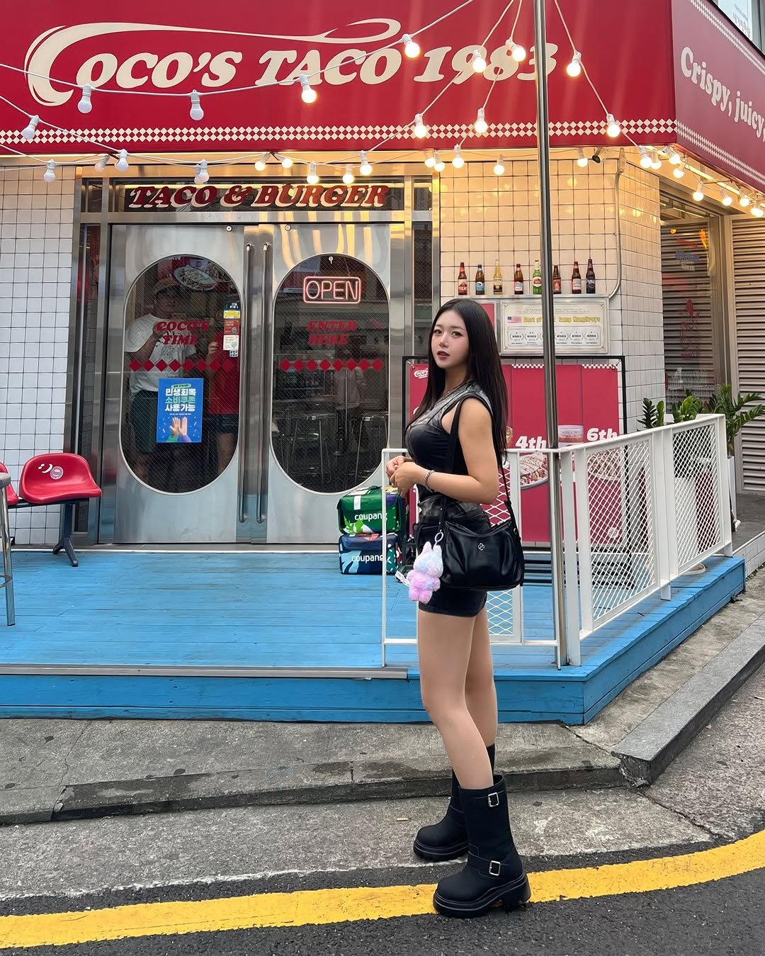 Photo shared by 지오 on August 10, 2025 tagging @shopheeari. May be an image of 1 person, miniskirt and text that says 'Cpco's TACO198 TACOGEURGER TAC0 BURGER Crisp juiy OPEN EN 민생최록 사표가들 m www 一9 www 4th 6th H ር cAиpan'.