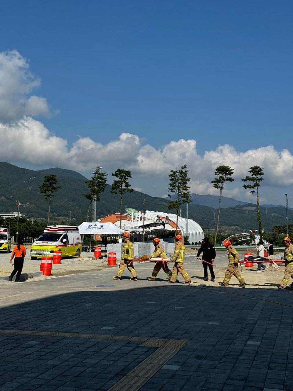 Photo by 2UC inc. on October 25, 2025. May be an image of one or more people, parasol, umbrella, cloud, road, terminal and text.