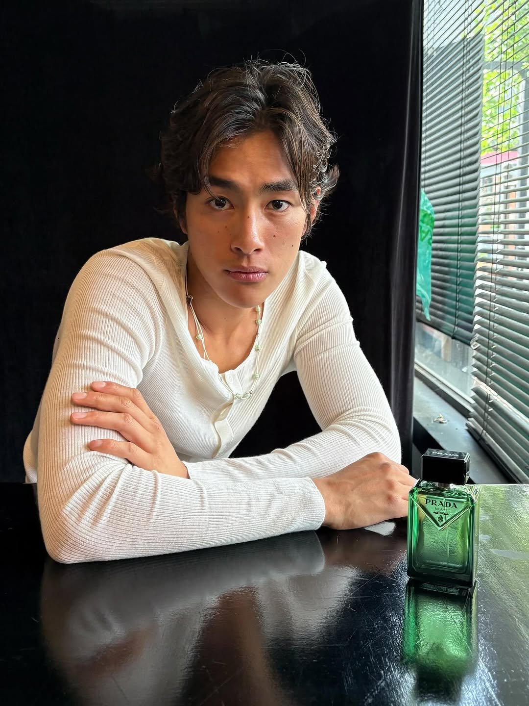 Photo shared by 홍태준 TaeJun on August 08, 2025 tagging @prada, and @pradabeauty. May be an image of 1 person, makeup, fragrance, top, perfume and text that says 'ORADA PRADA か'.