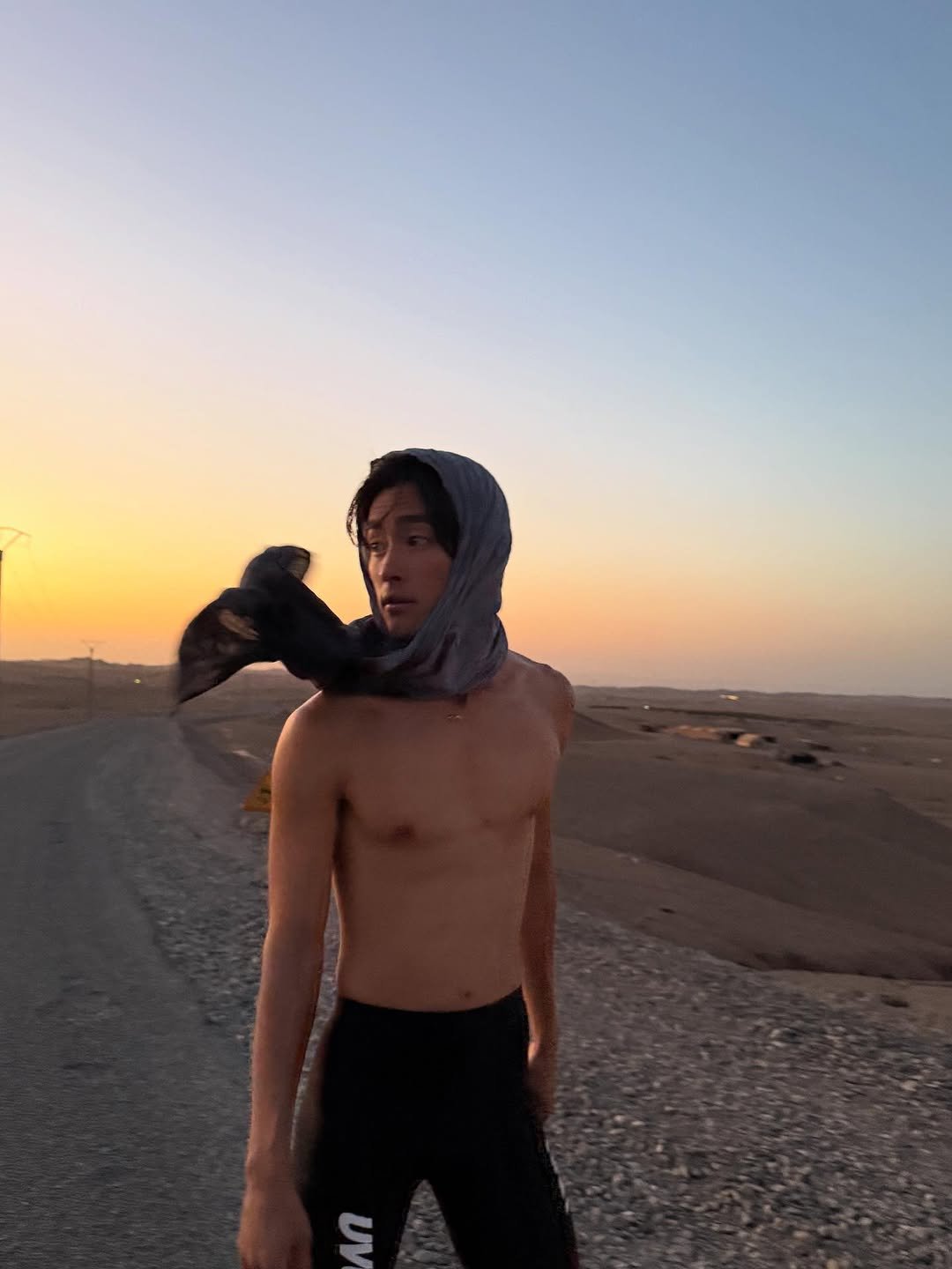 Photo by 홍태준 TaeJun on July 26, 2025. May be an image of 1 person, standing, sweatpants, face mask, sportswear, beach and text.