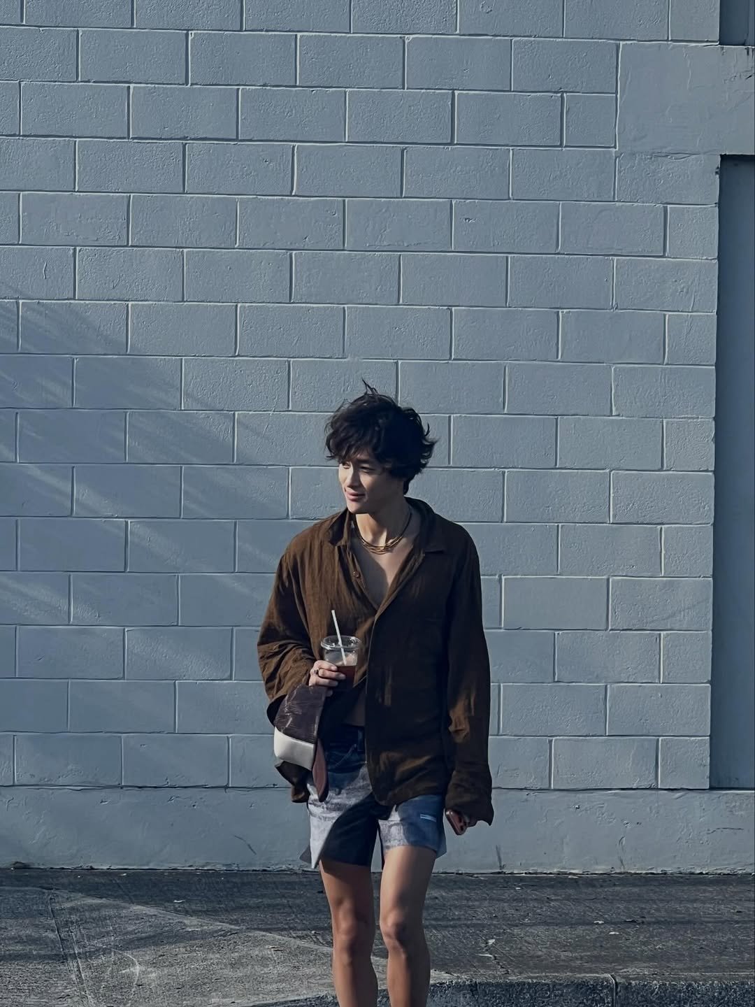 Photo by 홍태준 TaeJun on December 13, 2025. May be an image of duffle coat, overcoat, brick wall and text.