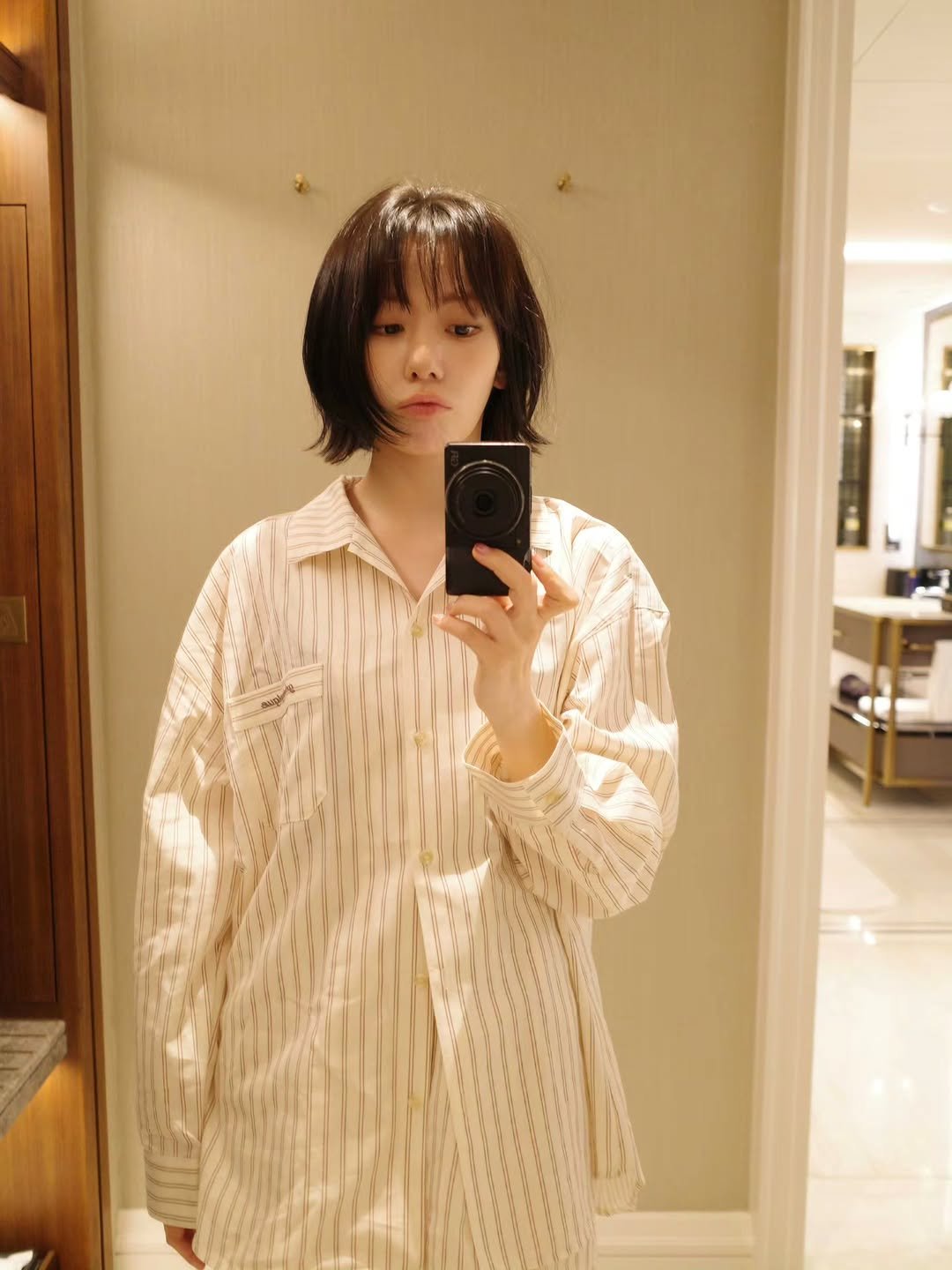 Photo by Sakura Miyawaki on March 26, 2026. May be a selfie of sleepwear, robe, bath robe and text.