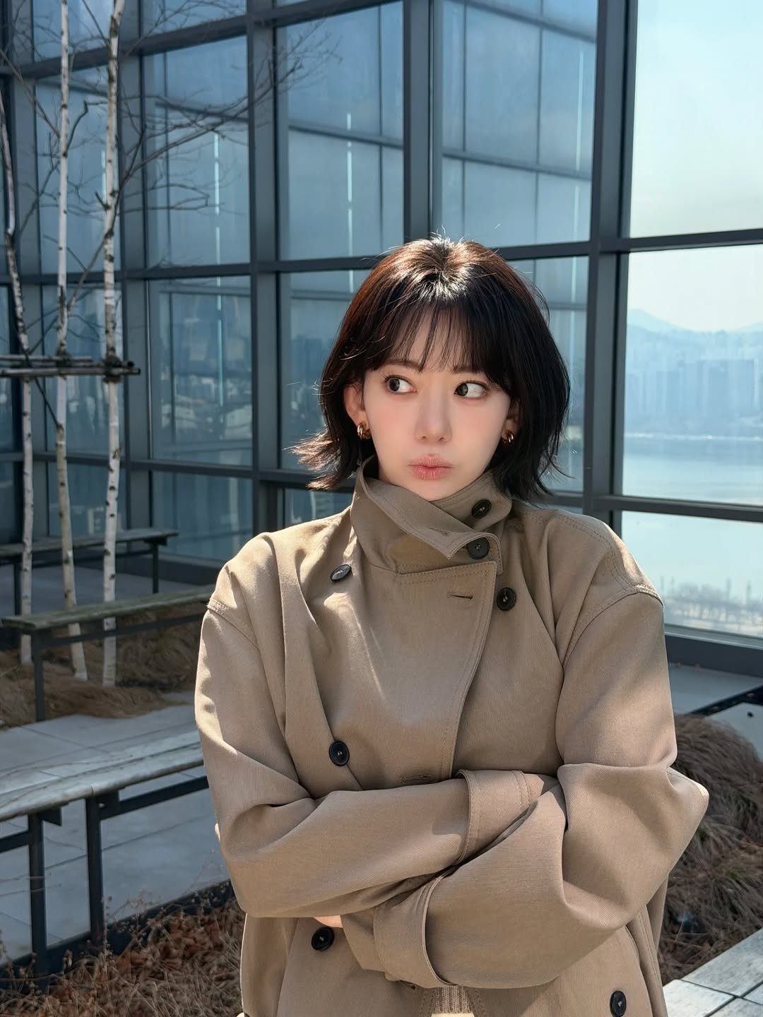 Photo by Sakura Miyawaki on March 12, 2026. May be an image of duffle coat, overcoat, jacket, turtleneck, parka and text.