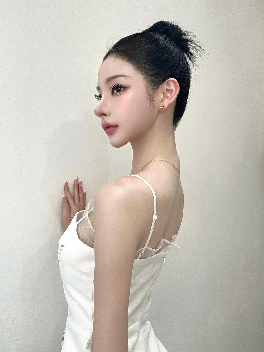 Photo shared by 권은지 on August 27, 2025 tagging @stonehenge_official. May be an image of 1 person, braids, slip, dress and text.