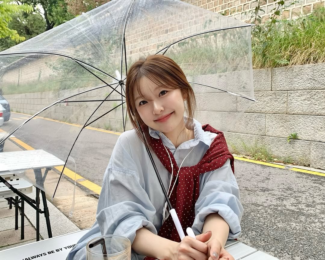 Photo by 나히 on October 04, 2025. May be an image of 1 person, raincoat, parka, parasol, umbrella, outdoors and text.