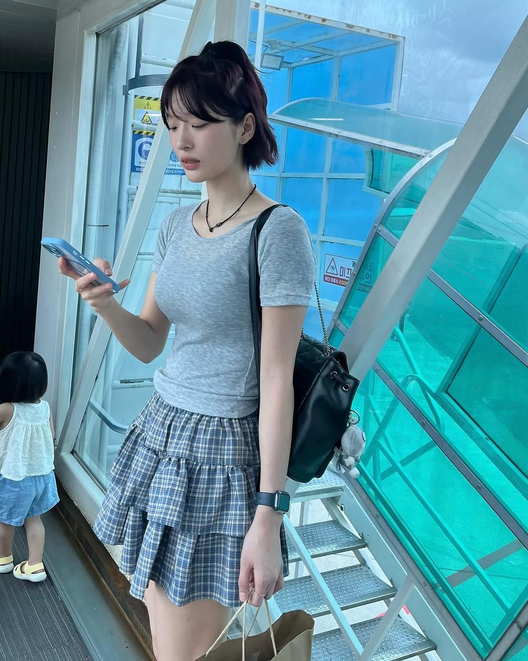 Photo by min on July 21, 2025. May be an image of 2 people, top, miniskirt, skirt and text.
