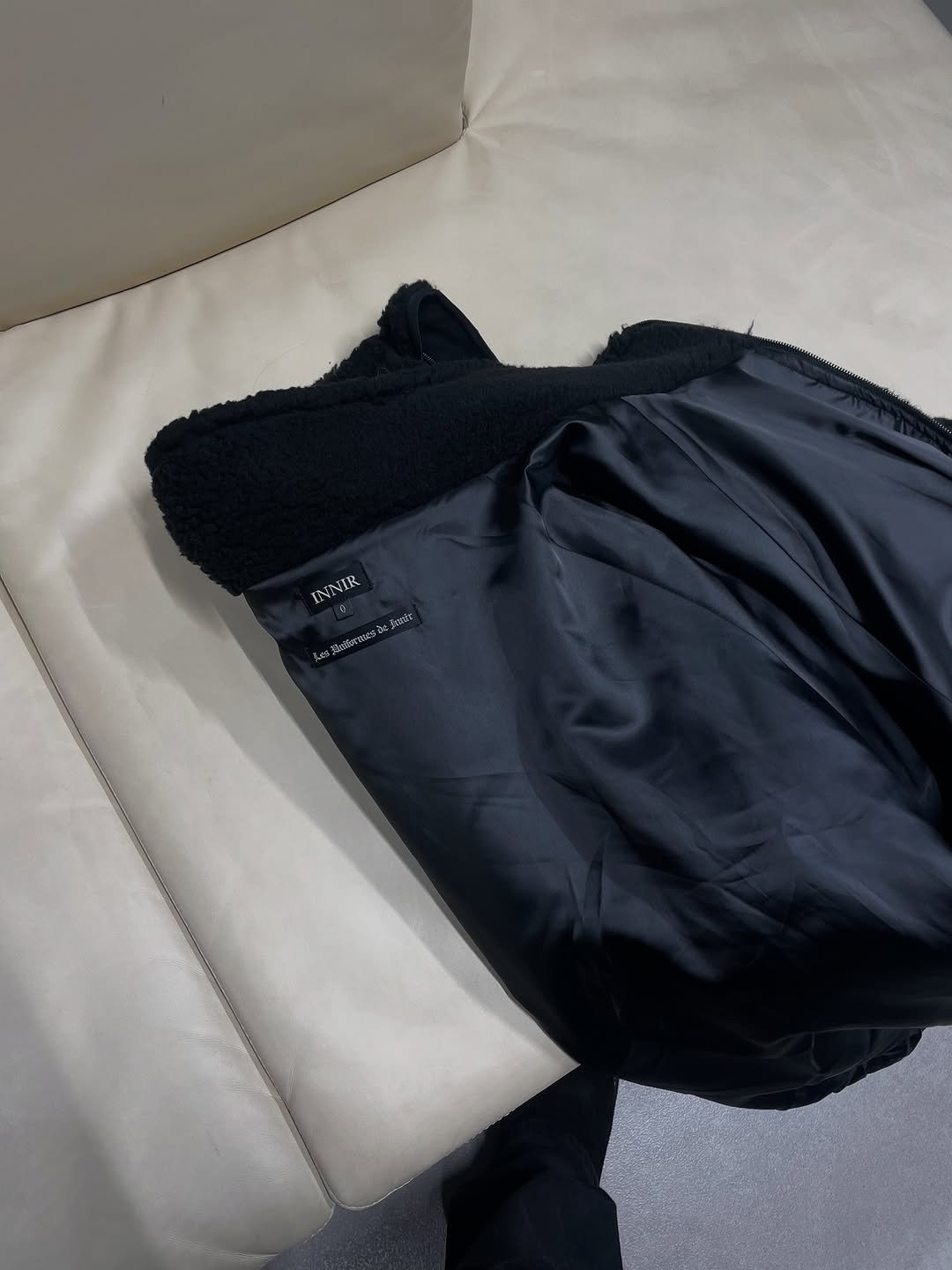 Photo shared by INNIR on November 05, 2025 tagging @8division, and @101floorelevators. May be an image of duffle coat, goosedown coat, fleece, parka and text.