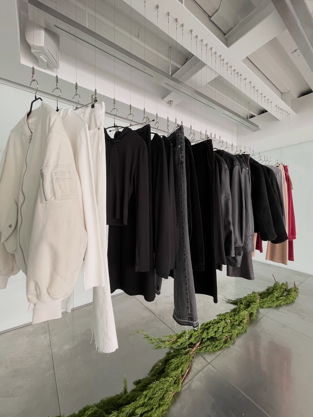 Photo shared by INNIR on December 13, 2025 tagging @heoshingu, @8division, and @101floorelevators. May be an image of overcoat, clothes hanger, coat rack, rack and text.