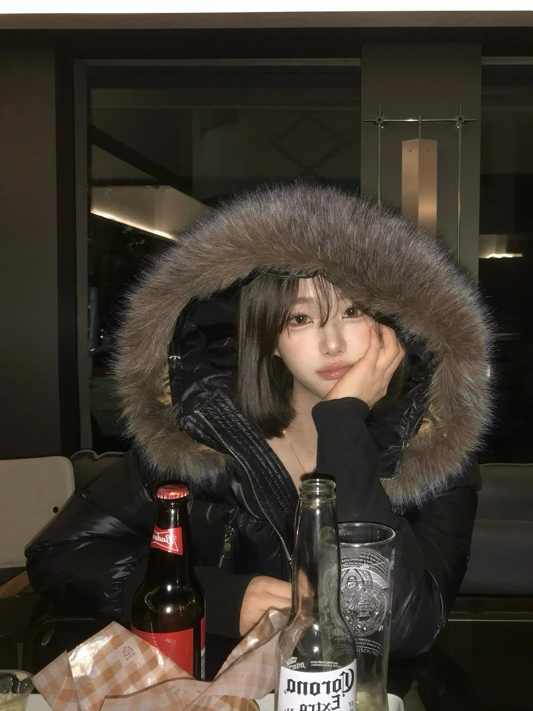 Photo shared by 백여경 on November 29, 2025 tagging @baeklit.kr. May be an image of duffle coat, beer, goosedown coat, fur coat, bottle, parka, jacket and text.