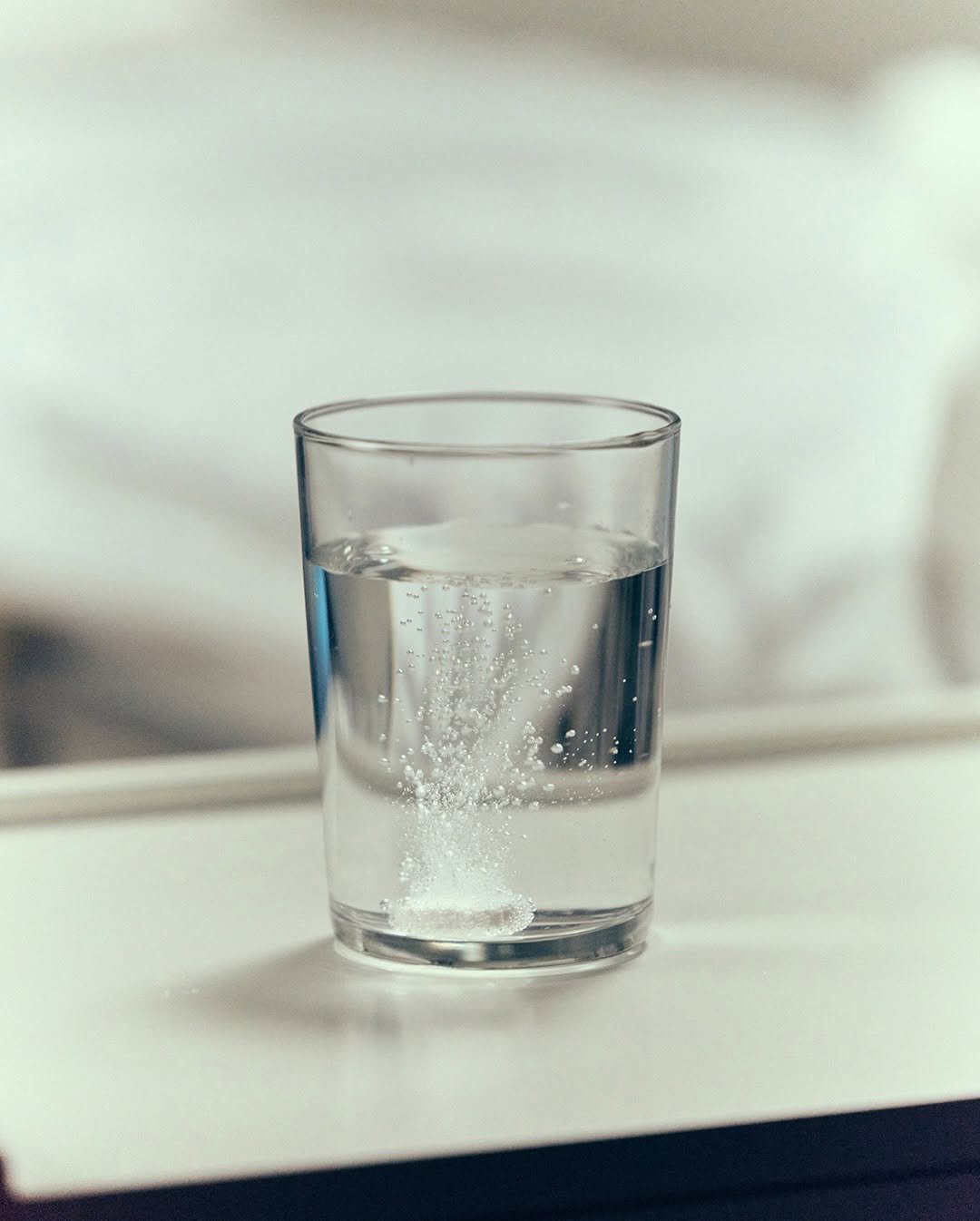 Photo by SM Entertainment Group on December 07, 2025. May be an image of sparkling water, shot glass, carafe, water filter, water bottle, body of water and text.