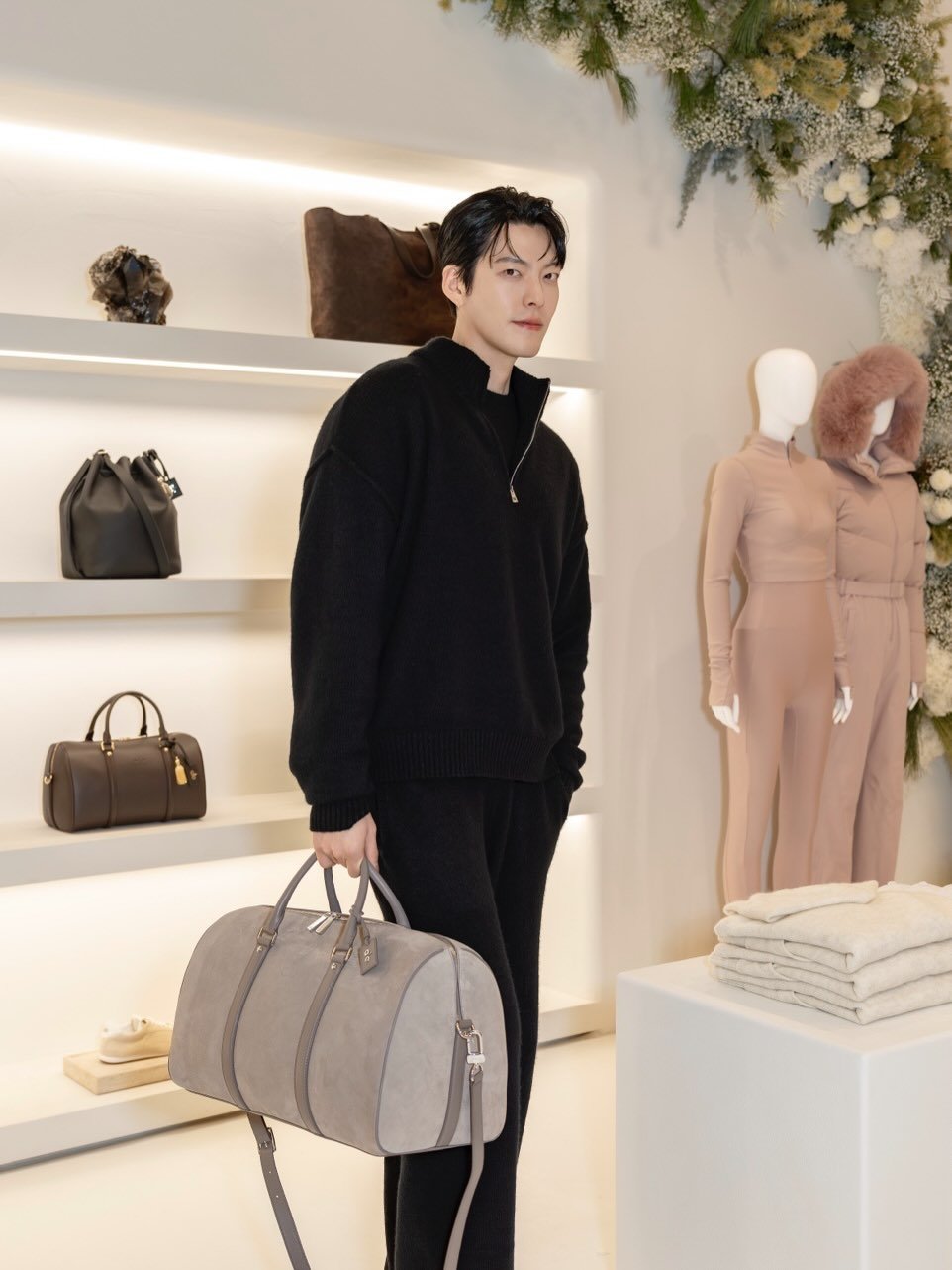 Photo shared by 김우빈 on December 15, 2025 tagging @alo, and @aloseoul. May be an image of sweatpants, briefcase, purse, display case and text.