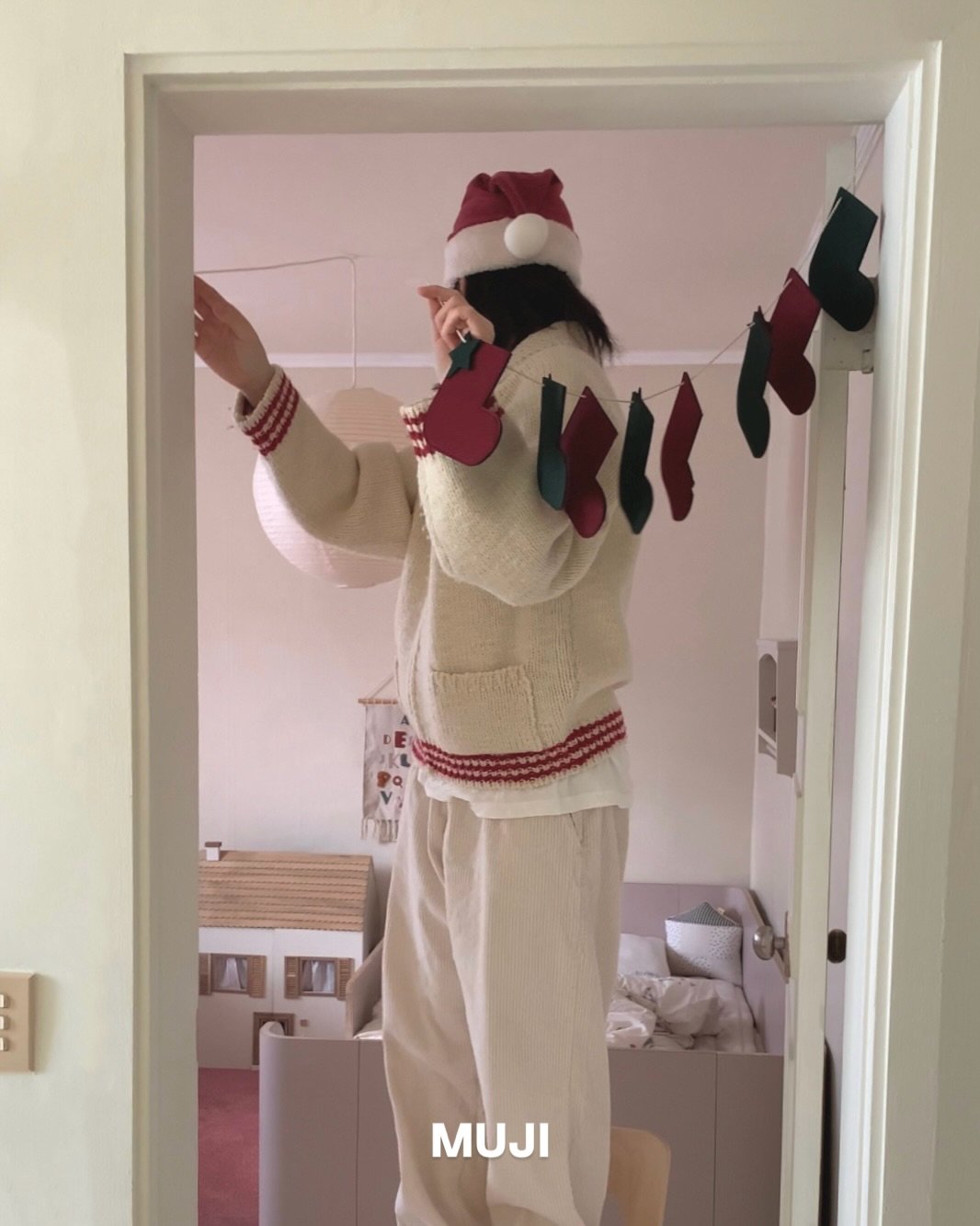 Photo shared by MIJI on December 18, 2025 tagging @mujikr. May be an image of sweater, bath robe, tinsel and text.