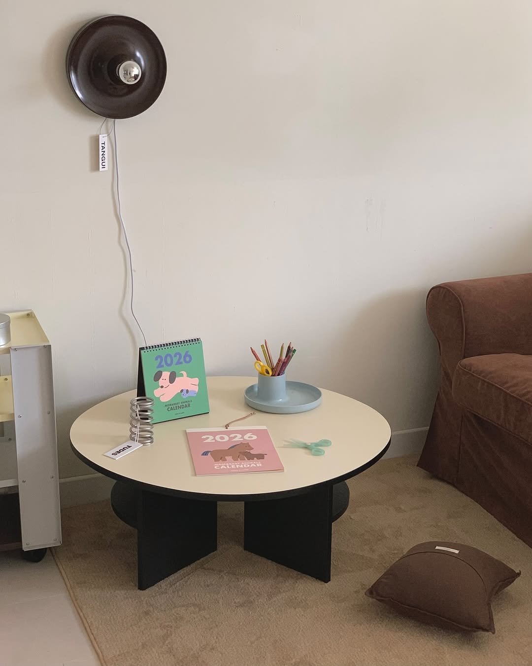 Photo shared by MIJI on October 29, 2025 tagging @tangui.official, @fmh_official, and @moss_carpet_. May be an image of table, lamp shade, desk, office and text.