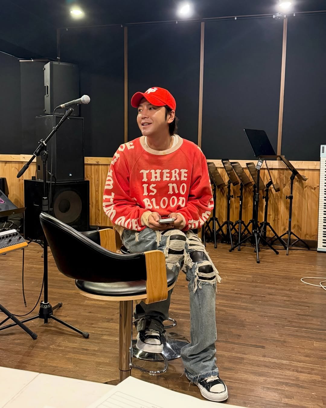 Photo by 장근석 Jang Keun-suk on April 01, 2026. May be an image of musical instrument, sweater, microphone, sweatpants and text that says 'THERE ISno IS no BLOOD L'.