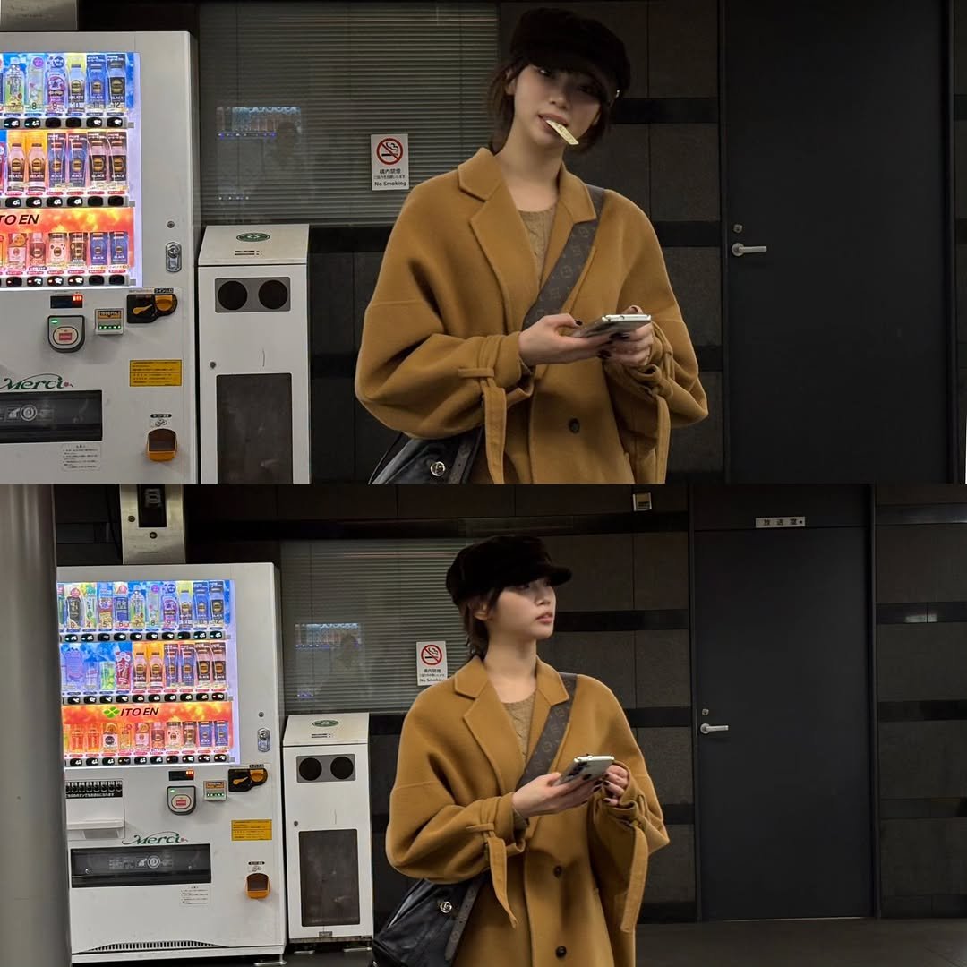 Photo by 김채원 (CHAEWON) on November 20, 2025. May be an image of duffle coat, overcoat, cigarette, parka, blazer, jacket, newsstand and text.