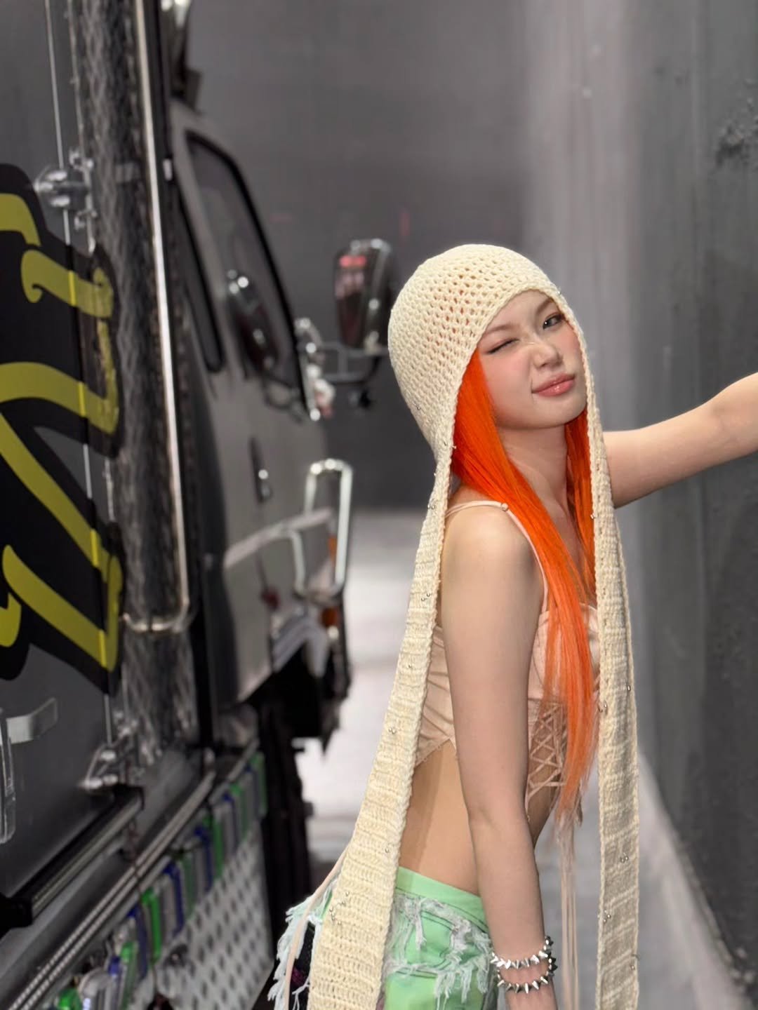 Photo by 김채원 (CHAEWON) on October 25, 2025. May be an image of one or more people, braids, blonde hair, turban, headscarf, bus and text.