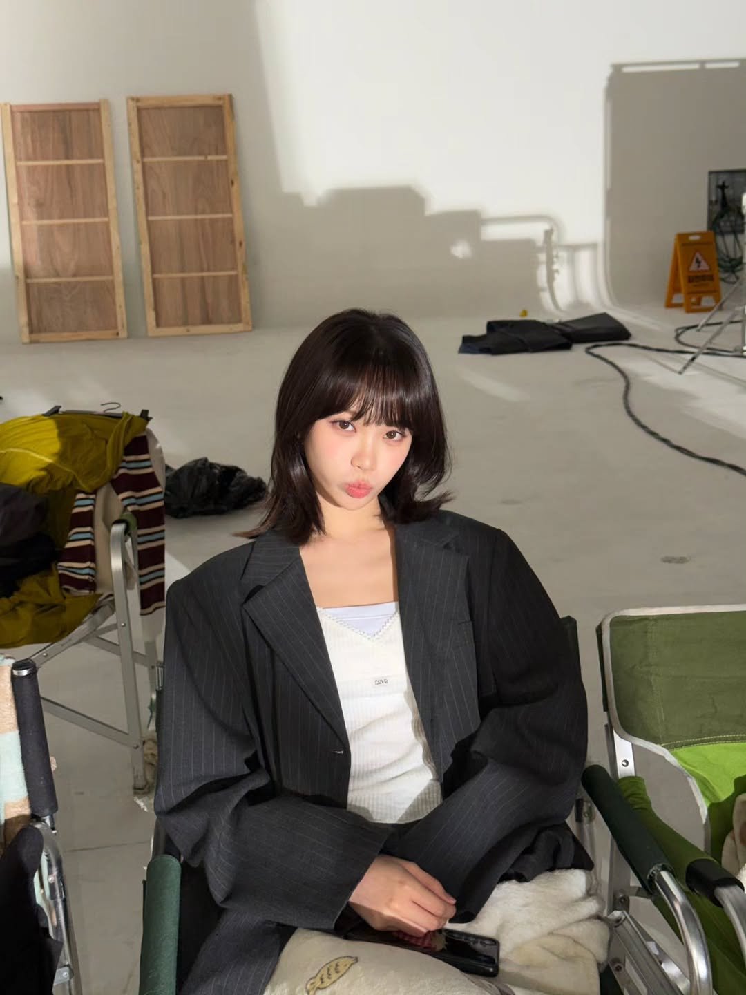 Photo shared by 김채원 (CHAEWON) on November 11, 2025 tagging @wconceptkorea. May be an image of one or more people, hair, makeup, blazer and text.