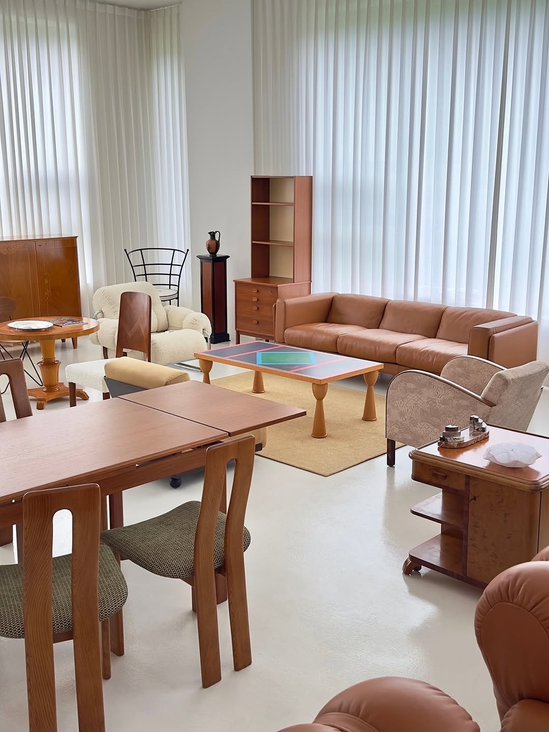 Photo by COLLECTION OF on October 02, 2025. May be an image of table, sofa, dining table, armchair, indoors, living room and text.