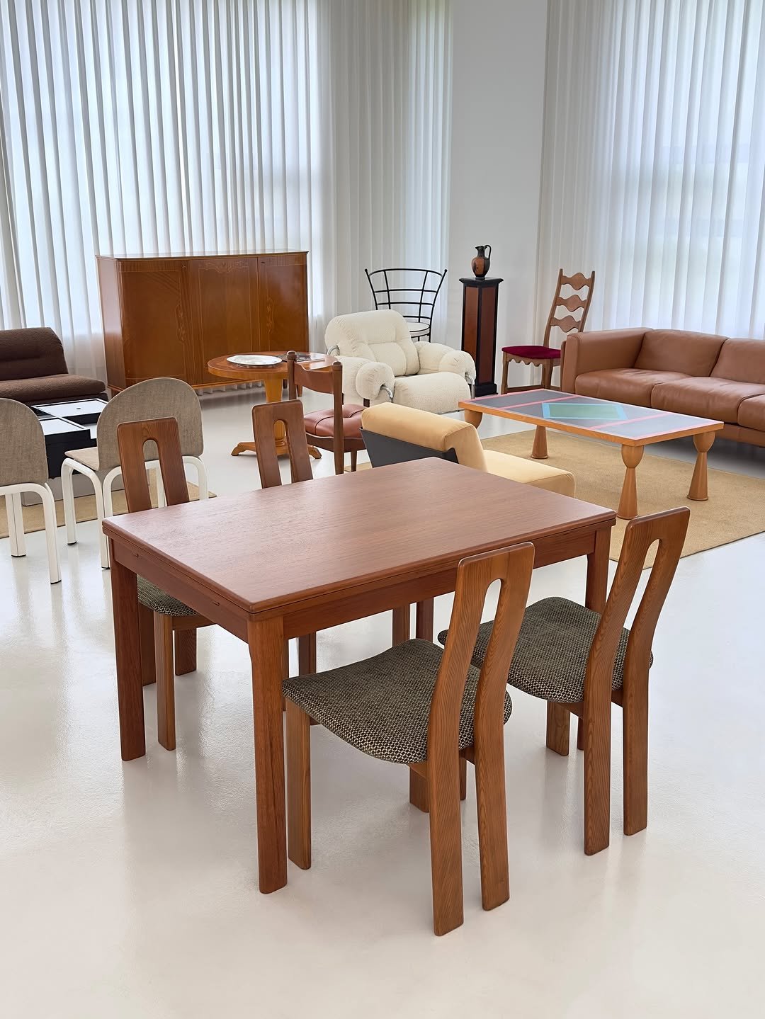 Photo by COLLECTION OF on September 25, 2025. May be an image of table, credenza, armchair, sofa, dining table, indoors and text.