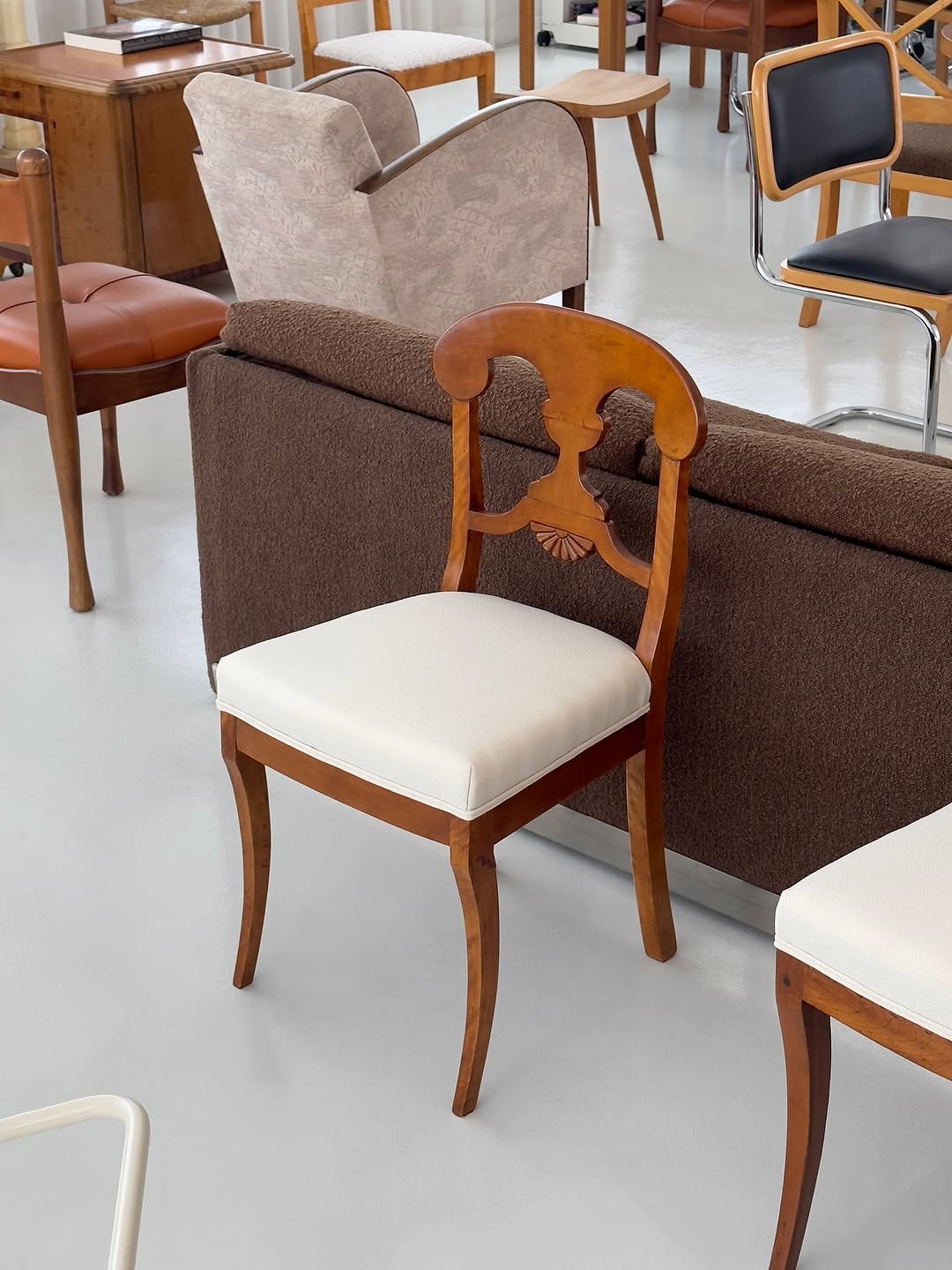 Photo by COLLECTION OF on August 20, 2025. May be an image of table, armchair, dining table, chair, indoors and text.