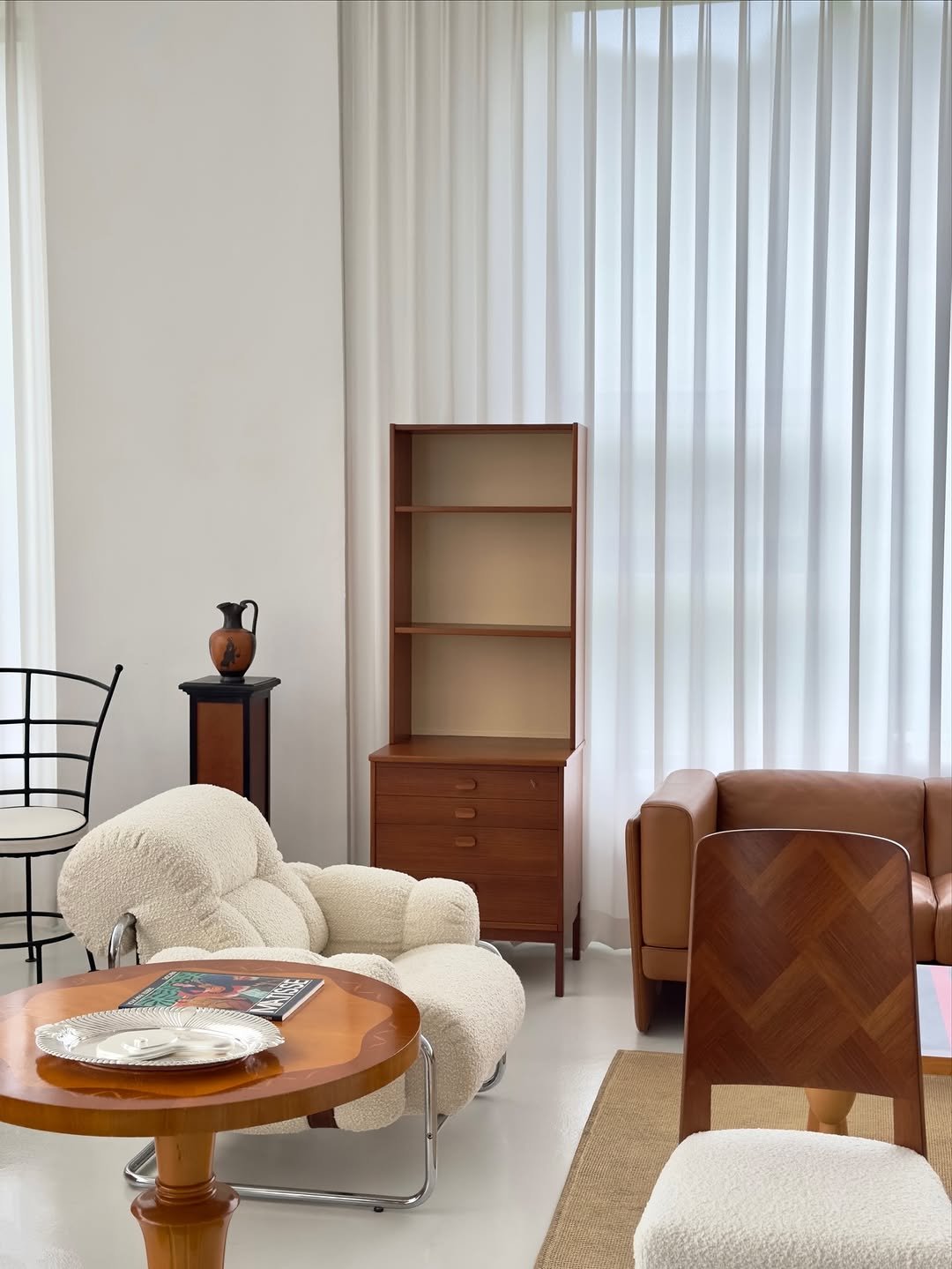 Photo by COLLECTION OF on October 16, 2025. May be an image of sink, curtains, armchair, chaise lounge, sofa, sliding door, indoors and text.