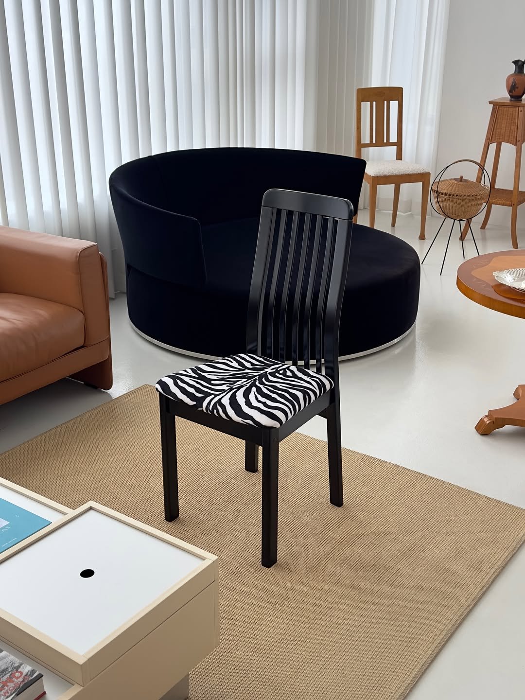 Photo by COLLECTION OF on December 09, 2025. May be an image of armchair, sofa, chaise lounge, chair, ottoman, indoors, living room and text.