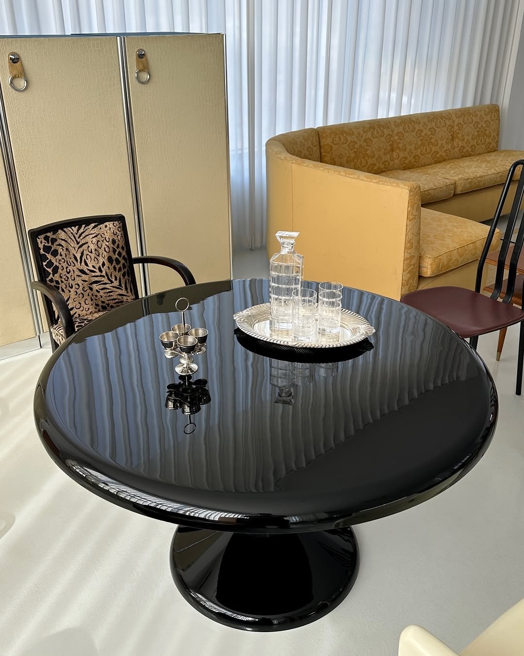 Photo by COLLECTION OF in Collection Of. May be an image of table, armchair, dining table, indoors and text.