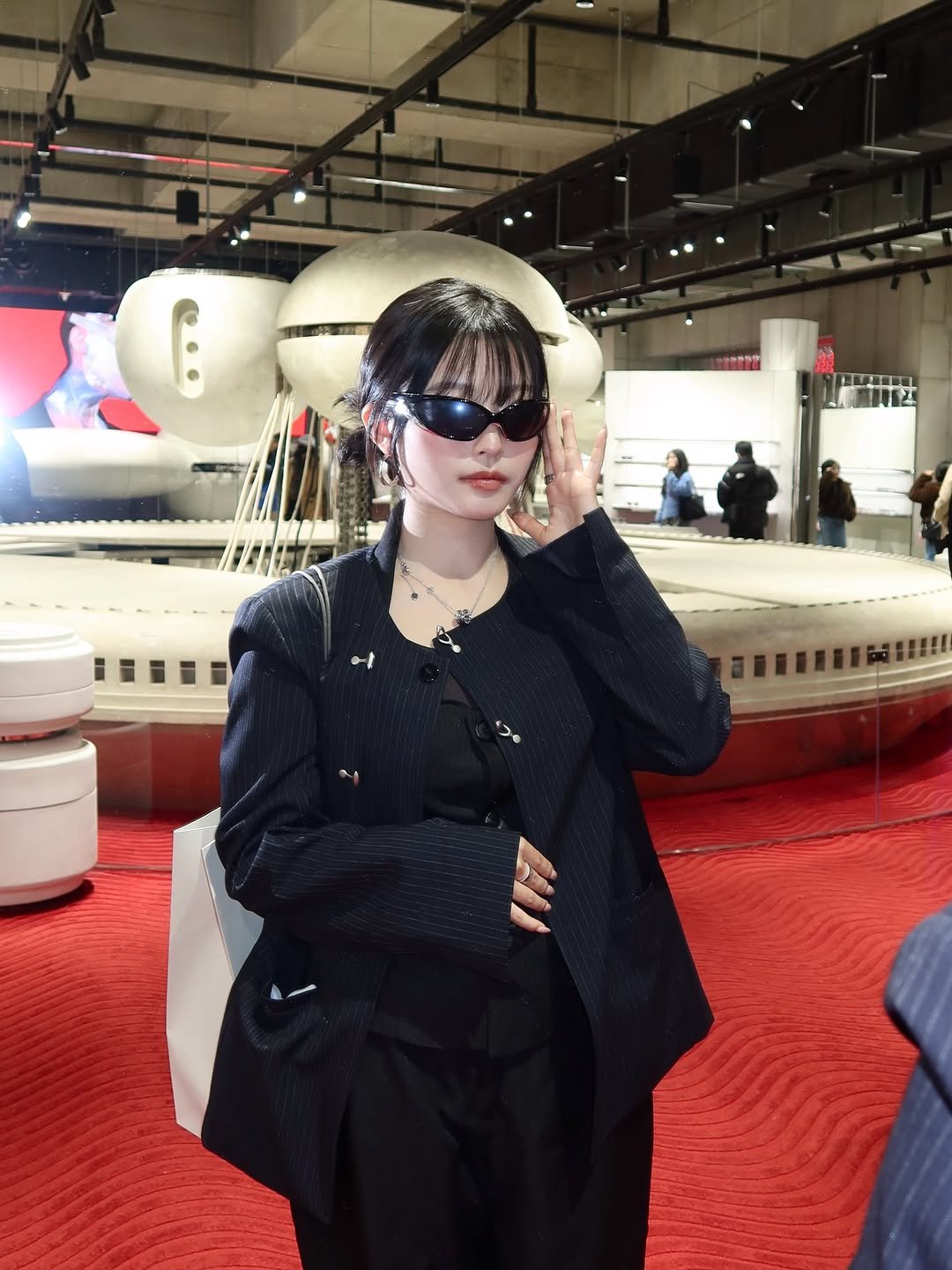 Photo shared by 김은솔 on January 06, 2026 tagging @gentlemonster, and @kuhoplus_official. May be an image of helicopter, suit, glasses, blazer, eye patch and text.