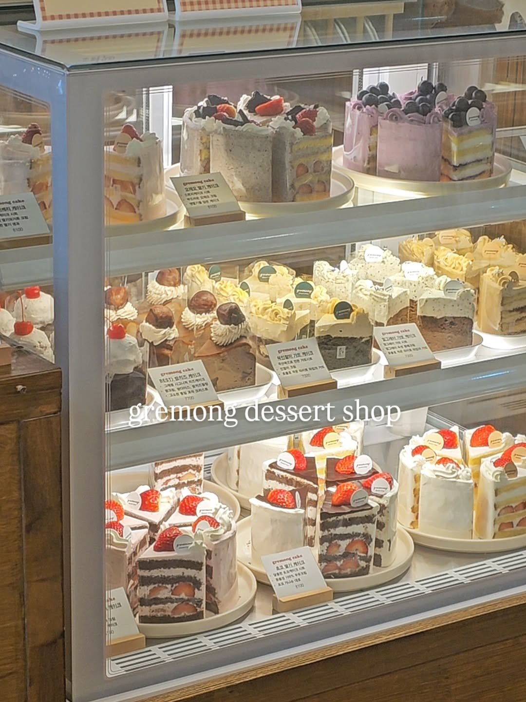 Photo by 그레몽디저트샵/ 배곧디저트카페/배곧생크림케이크 on February 14, 2026. May be an image of cake, display case and text.