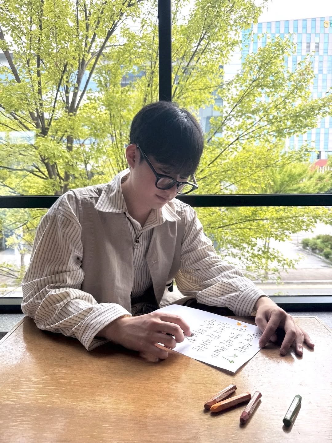 Photo shared by 하승완 on September 21, 2025 tagging @fujifilm_korea_photo. May be an image of 1 person, studying, eyeglasses, pen and text.
