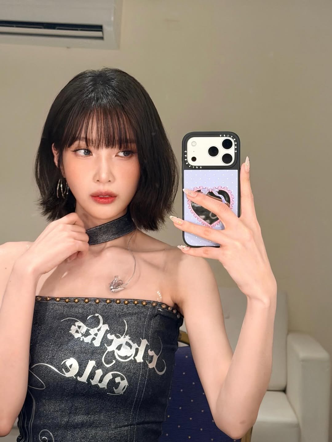 Photo by Joy on November 23, 2025. May be a selfie of one or more people, hair, phone, choker, top, mirror and text.