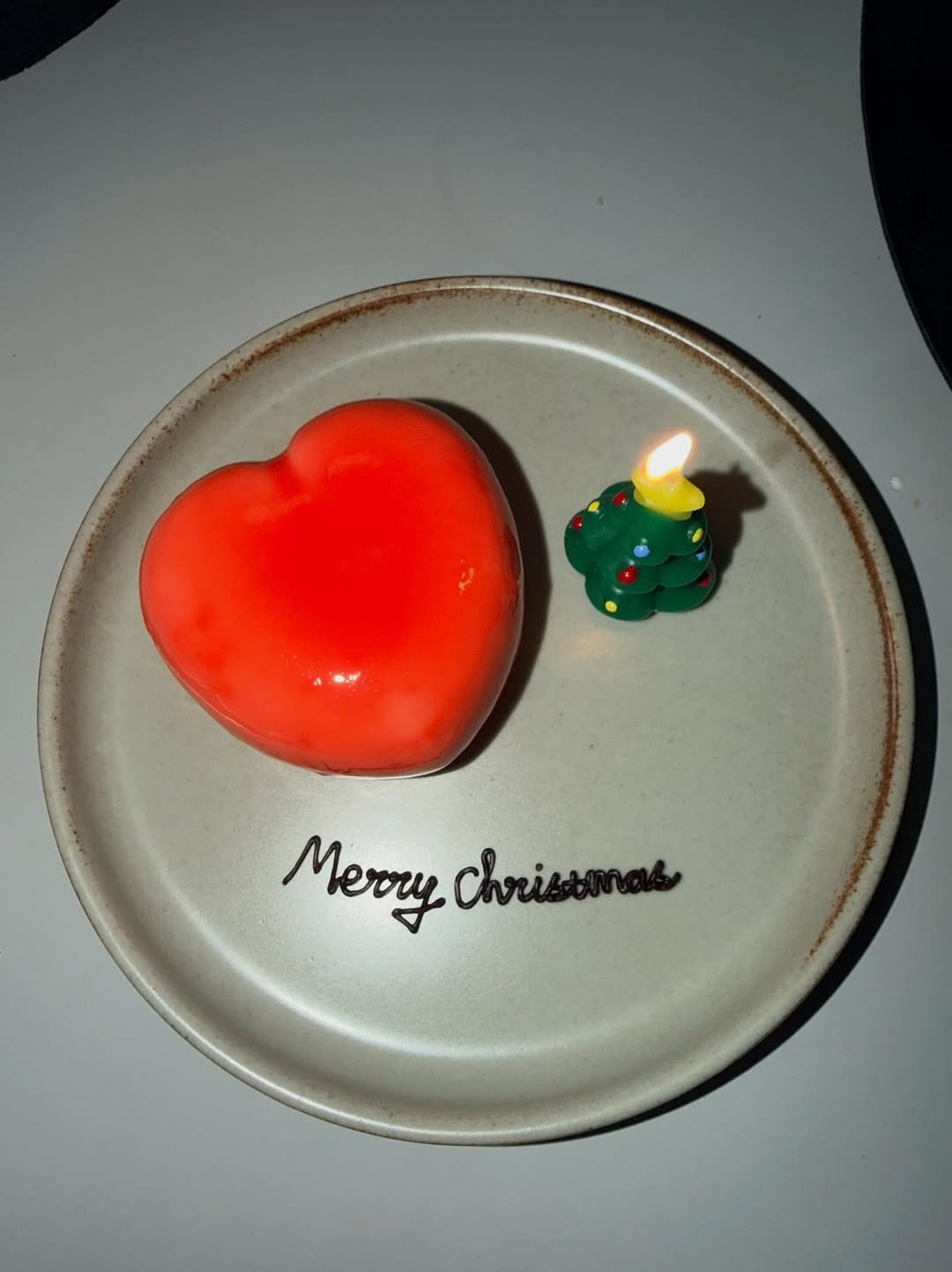 Photo by Joy on December 25, 2025. May be an image of cake, strawberry, heart, fruitcake, candle and text.