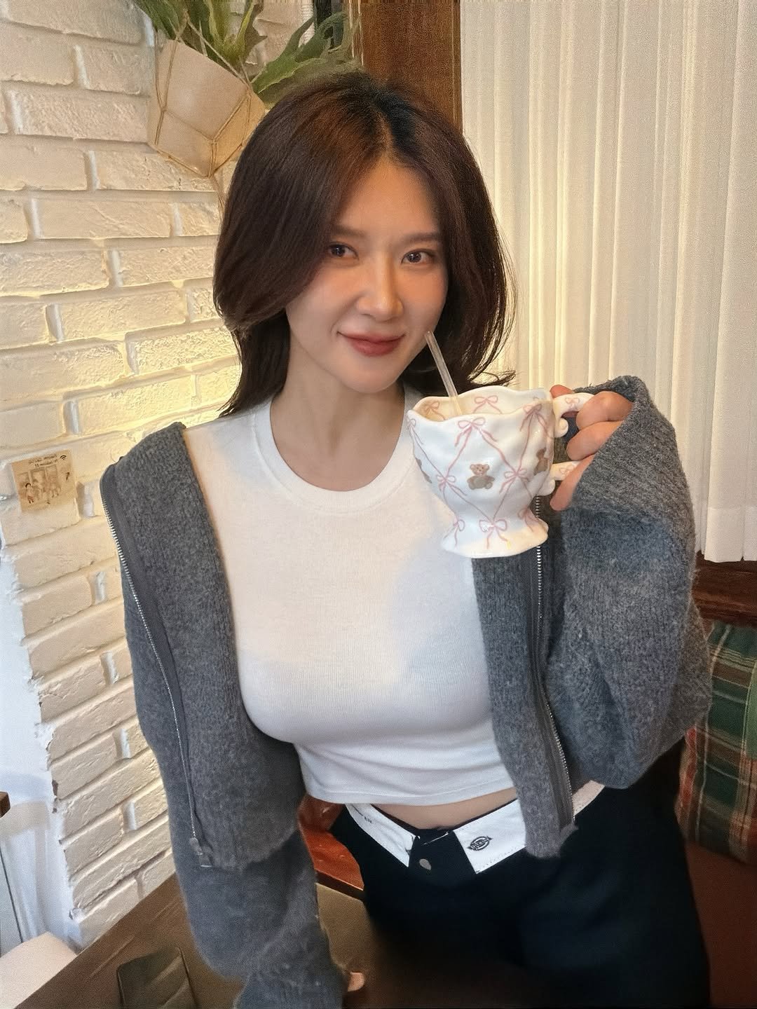 Photo shared by 🦦 on November 26, 2025 tagging @yurie__ps. May be an image of one or more people, hair, coffee cup, top, turtleneck, tea, knit and text.