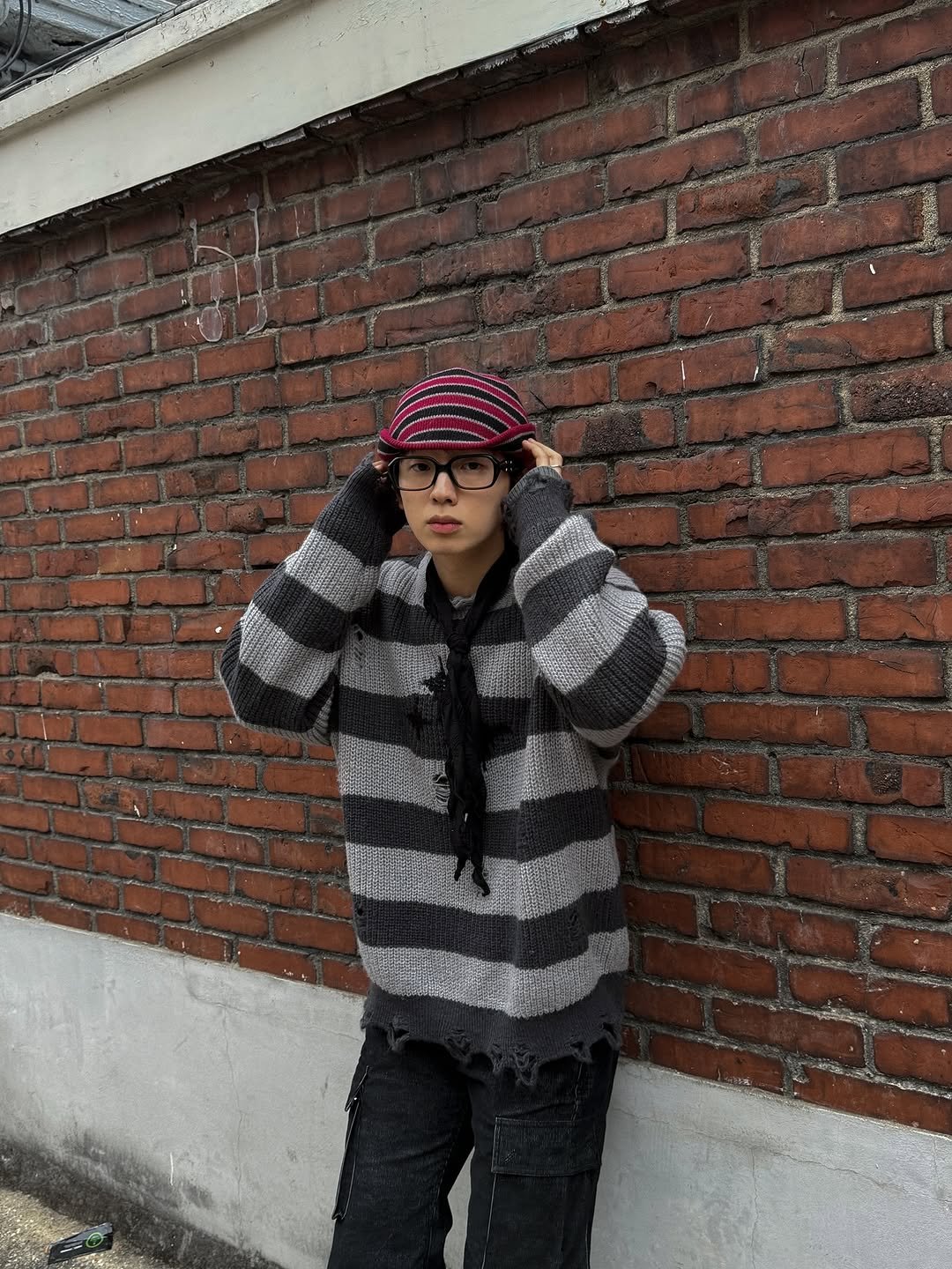 Photo shared by 이준혁 on November 21, 2025 tagging @mea_seoulkr. May be an image of duffle coat, hat, sweater, beret, fleece, knit, brick wall and text.