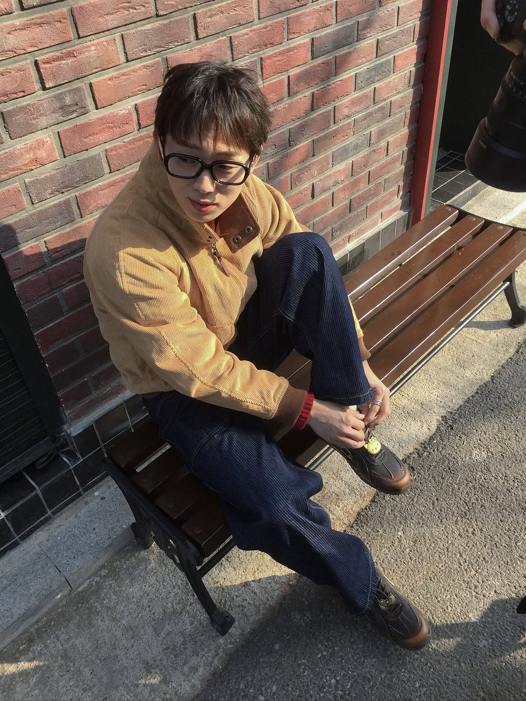 Photo shared by 이준혁 on November 23, 2025 tagging @ertr_____. May be an image of duffle coat, wingtip shoes, cigarette and text.