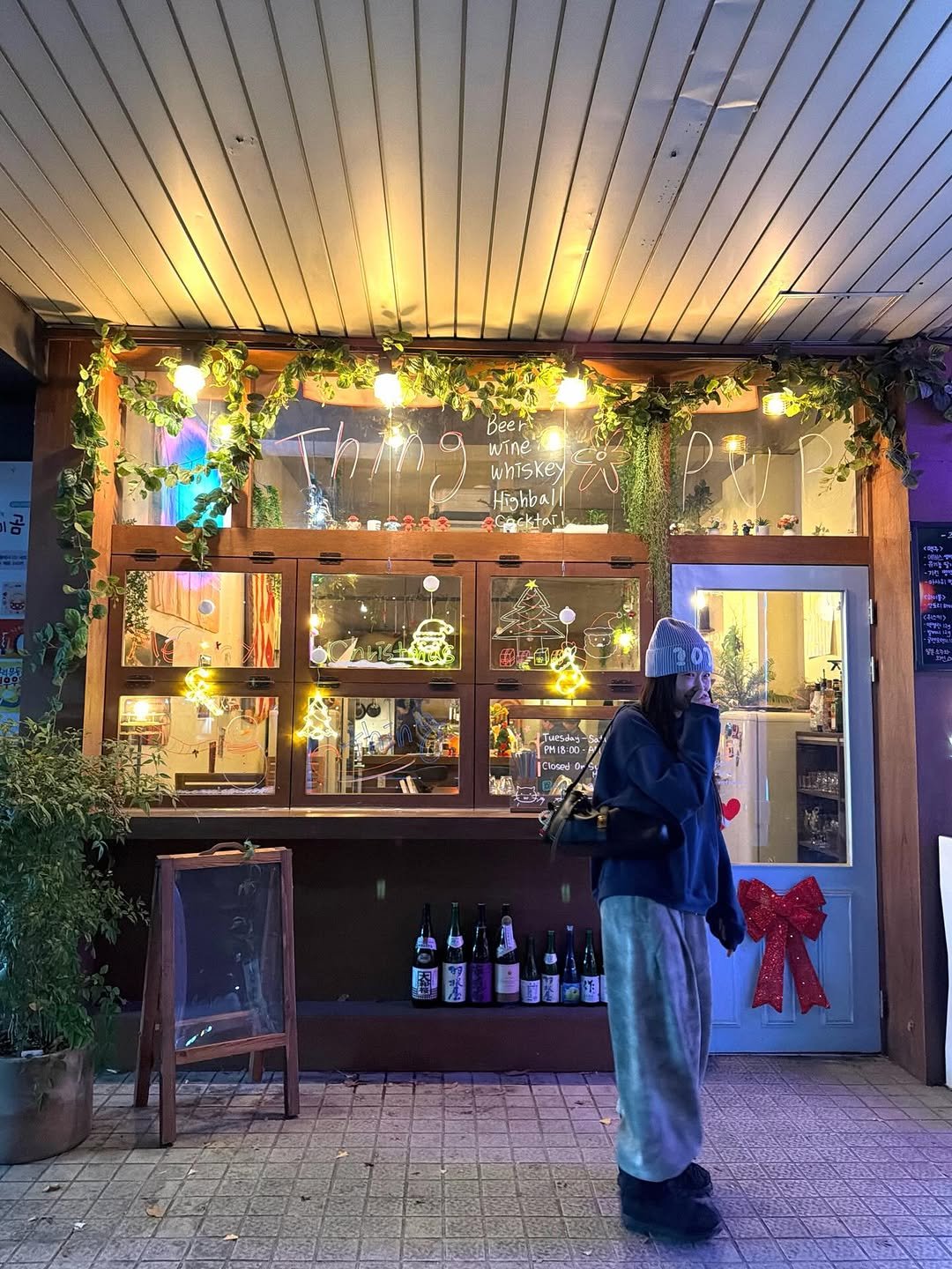 Photo shared by 이주은 on December 13, 2025 tagging @metrocity.korea, and @metrocity__official. May be an image of one or more people, duffle coat, wind chime, lantern, wine bottle and text.