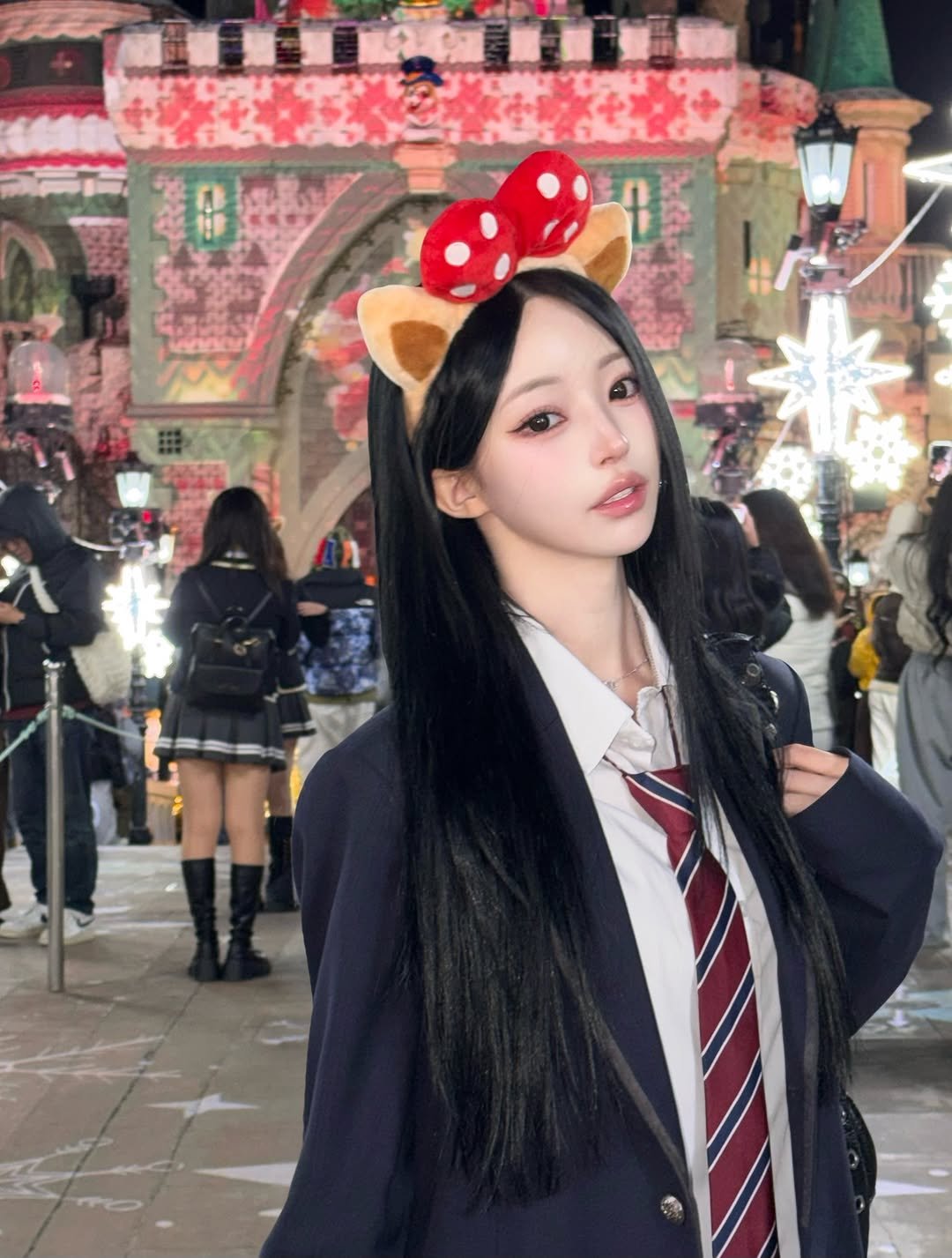 Photo by 주연 on December 21, 2025. May be an image of one or more people, hair, costume, miniskirt, cloak and text.