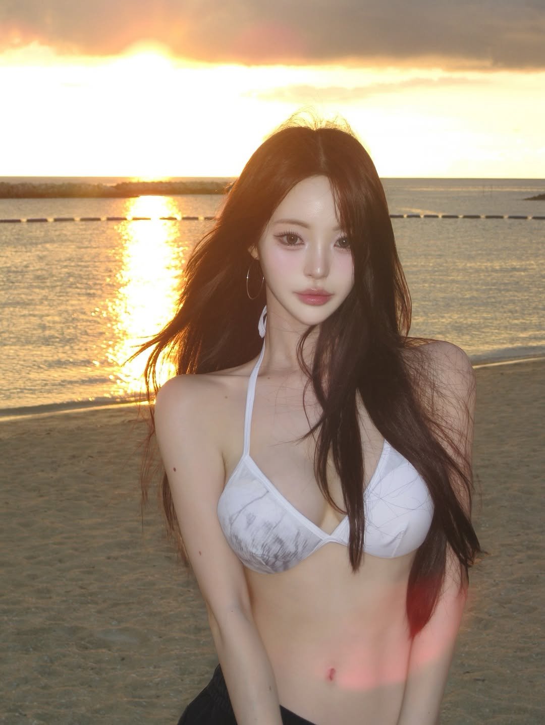 Photo shared by 주연 on July 27, 2025 tagging @sullimofficial. May be an image of 1 person, hair, bra, beach and text.