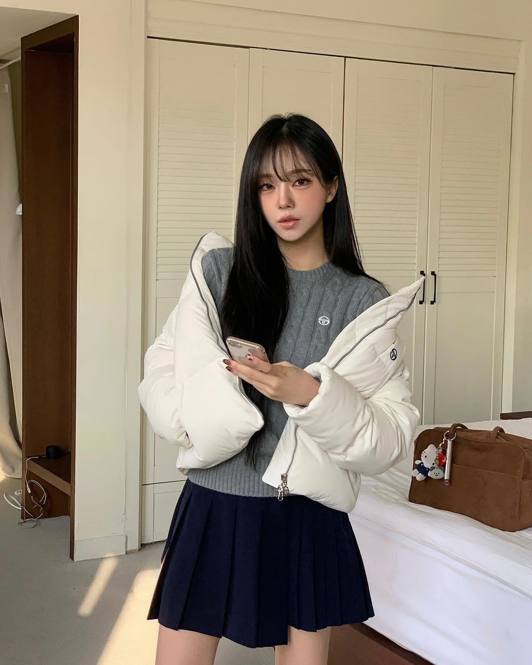 Photo shared by 임서현 on November 07, 2025 tagging @sergiotacchini_kr. May be an image of duffle coat, flight jacket, turtleneck, miniskirt, top, parka and text.