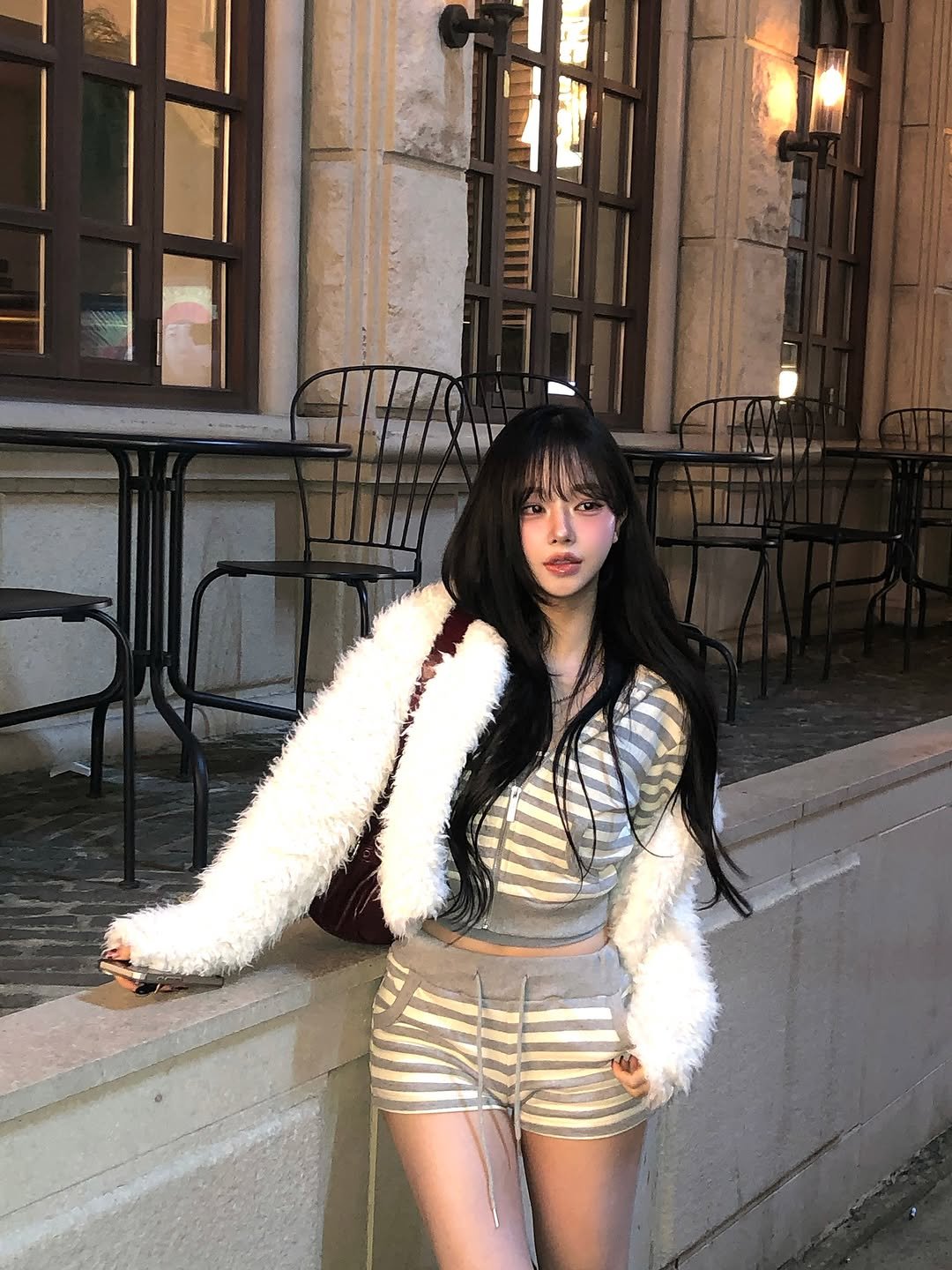 Photo by 임서현 on November 13, 2025. May be an image of beret, turtleneck, fur, miniskirt, fishnet stockings and text.